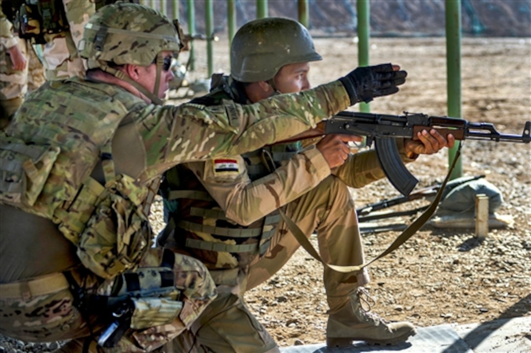 U.S. Army Spc. Justin Yarnell, left, helps an Iraqi soldier during a weapons qualification on Camp Taji, Iraq, March 8, 2015. Yarnell is assigned to the 82nd Airborne Division's Company C, 2nd Battalion, 505th Parachute Infantry Regiment, 3rd Brigade Combat Team.