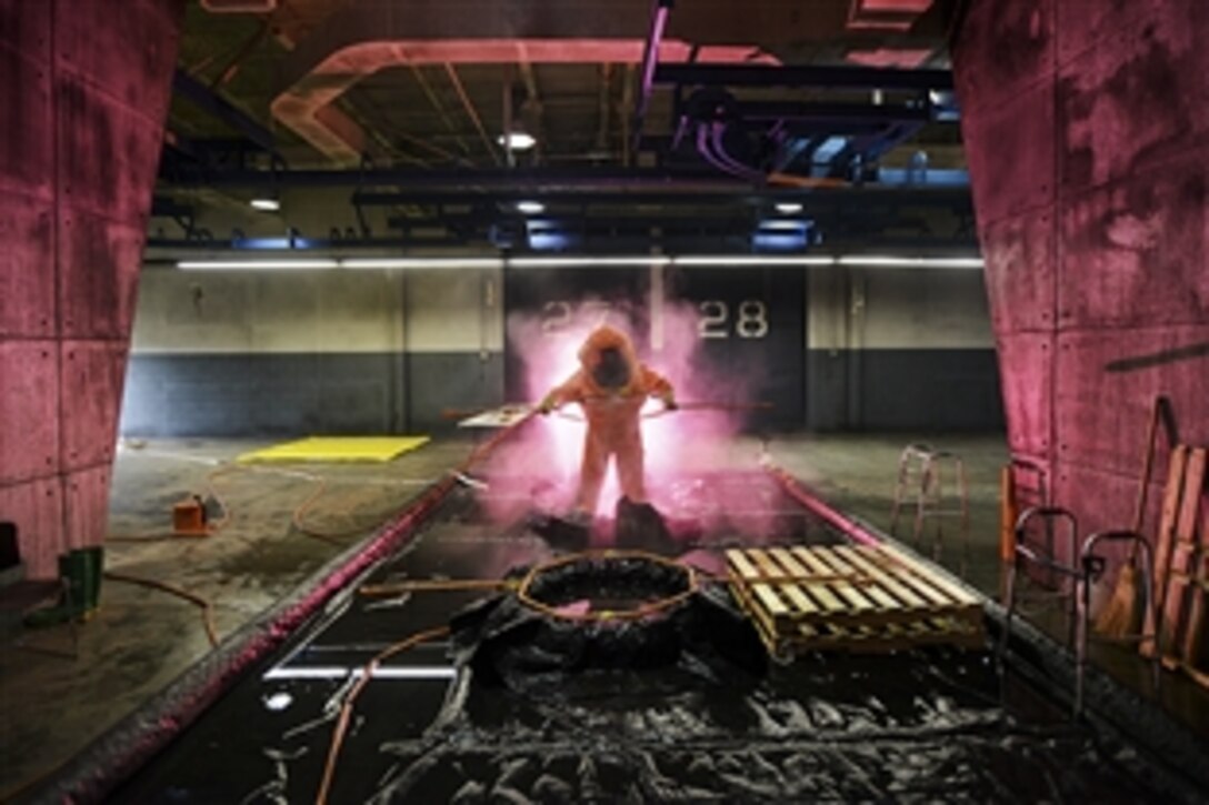 Air Force Tech. Sgt. Timothy Cotterall goes through a decontamination procedure after attempting to identify multiple biological contaminants in a simulated lab during a Global Dragon training event in Perry, Ga., March 18, 2015. The training provides a refresher course for airmen, allowing them to identify live chemical, biological, radiological and nuclear agents and materials. Cotterall is assigned to the 137th Air Refueling Wing. 
