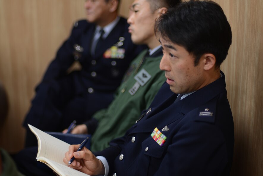 Japan Air Self-Defense Force Maj. Hitoshi Watanabe, Hamamatsu Air Rescue Squadron UH-60J pilot, takes notes during a search and rescue conference at Iruma Air Base, Japan, March 12, 2015. The conference highlighted SAR capabilities of the U.S. Air Force and the JASDF. (U.S. Air Force photo by Airman 1st Class David C. Danford/Released)
