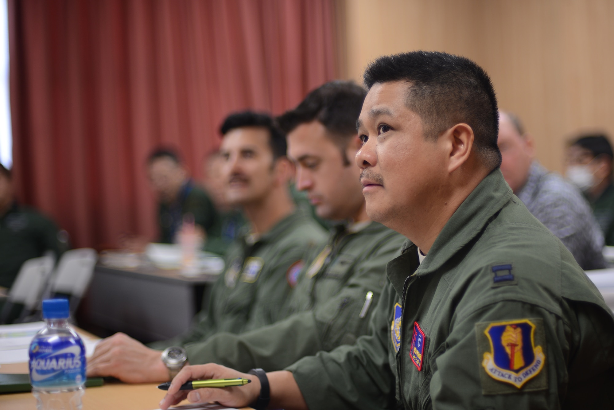 Capt. Joseph Teodoro, 35th Operations Support Squadron aerospace and operational physiologist, listens to a briefing at a search and rescue conference at Iruma Air Base, Japan, March 12, 2015. The conference highlighted SAR capabilities of the U.S. Air Force and the Japan Air Self-Defense Force. (U.S. Air Force photo by Airman 1st Class David C. Danford/Released)