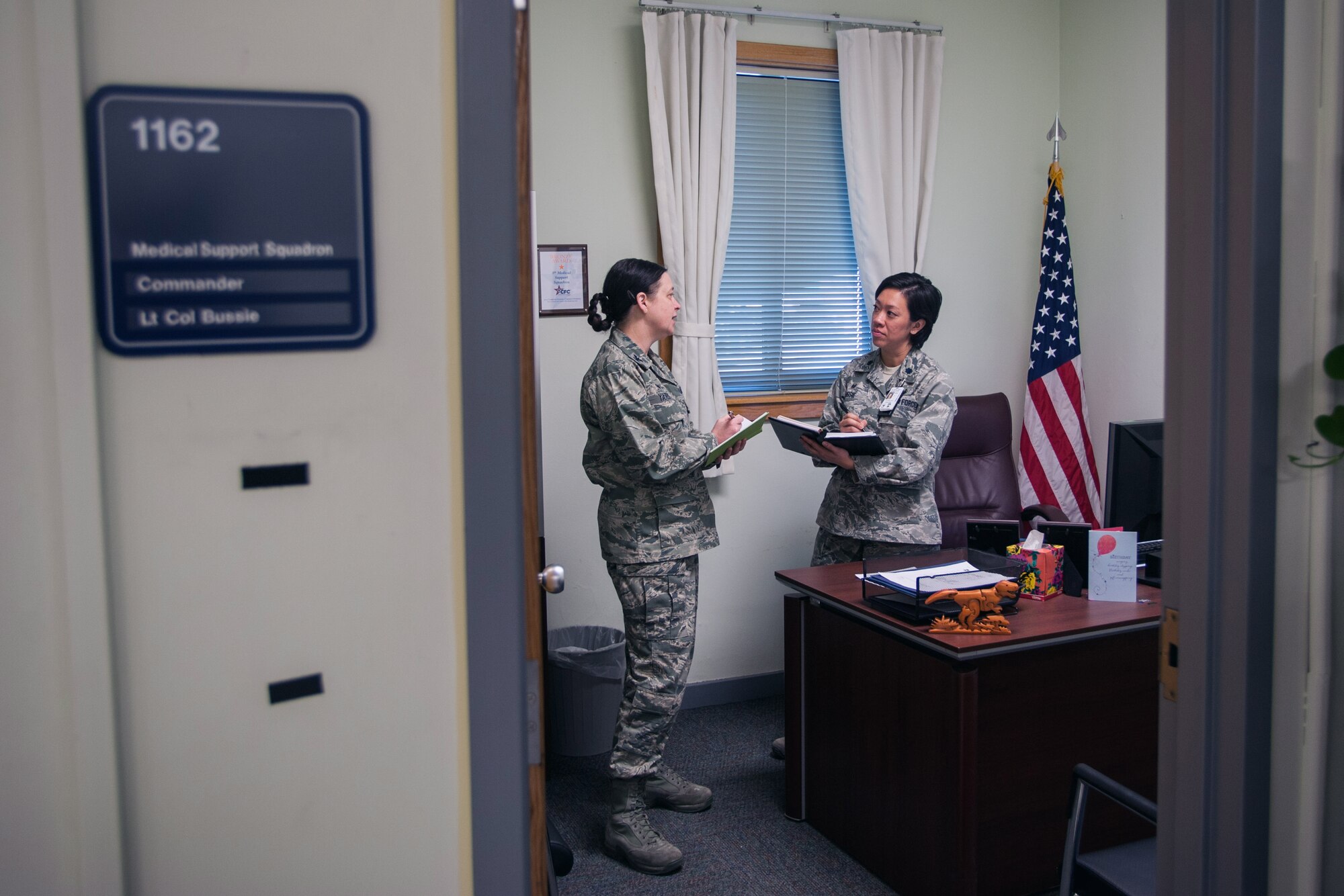 Col. Tambra “Hawk” Yates, 8th Medical Group commander, speaks with Lt. Col. Lynne Bussie, 8th Medical Support Squadron commander, at the medical clinic at Kunsan Air Base, Republic of Korea, March 10, 2015. Hawk oversees all medical programs, including support and clinical operations at the 8th MDG. (U.S. Air Force photo by Senior Airman Taylor Curry/Released) 