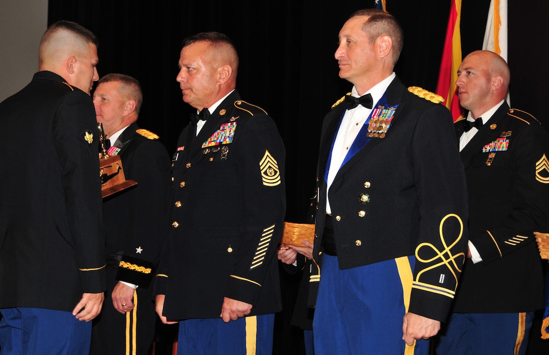 Spc. Aaron Hoyt accepts his award for Outstanding Soldiers of the Year from Brig. Gen. William Hall, Arizona Army National Guard land component commander, Command Sgt. Maj. Patrick Powers, Arizona Army National Guard state command sergeant major, and Chief Warrant Officer 5 Daniel Toporek, Army Command Chief Warrant Officer, at the Outstanding Soldier and Airmen of the Year banquet held at the Arizona Grand hotel, Phoenix, March 21. The annual OSAY banquet is held to honor the Soldiers and Airmen, the best of the best, of the Arizona Army and Air National Guard whose outstanding hard work, dedication, and professionalism has earned them recognition by their respective units. (U.S. Air National Guard photo by Tech. Sgt. Courtney Enos)
