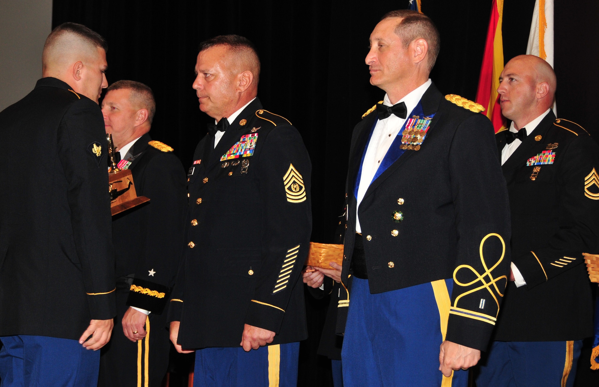 Spc. Aaron Hoyt accepts his award for Outstanding Soldiers of the Year from Brig. Gen. William Hall, Arizona Army National Guard land component commander, Command Sgt. Maj. Patrick Powers, Arizona Army National Guard state command sergeant major, and Chief Warrant Officer 5 Daniel Toporek, Army Command Chief Warrant Officer, at the Outstanding Soldier and Airmen of the Year banquet held at the Arizona Grand hotel, Phoenix, March 21. The annual OSAY banquet is held to honor the Soldiers and Airmen, the best of the best, of the Arizona Army and Air National Guard whose outstanding hard work, dedication, and professionalism has earned them recognition by their respective units. (U.S. Air National Guard photo by Tech. Sgt. Courtney Enos)