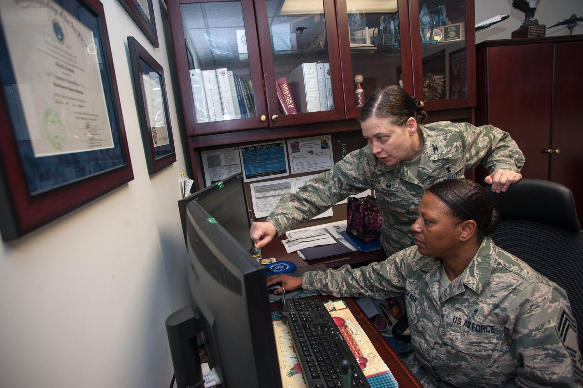 Col. Tambra “Hawk” Yates, 8th Medical Group commander, interacts with Chief Master Sgt. Erica “Hawk Chief” Jackson, 8th MDG superintendent, at the medical clinic at Kunsan Air Base, Republic of Korea, March 10, 2015. Hawk oversees all medical programs, including support and clinical operations at the 8th MDG. (U.S. Air Force photo by Senior Airman Taylor Curry/Released) 