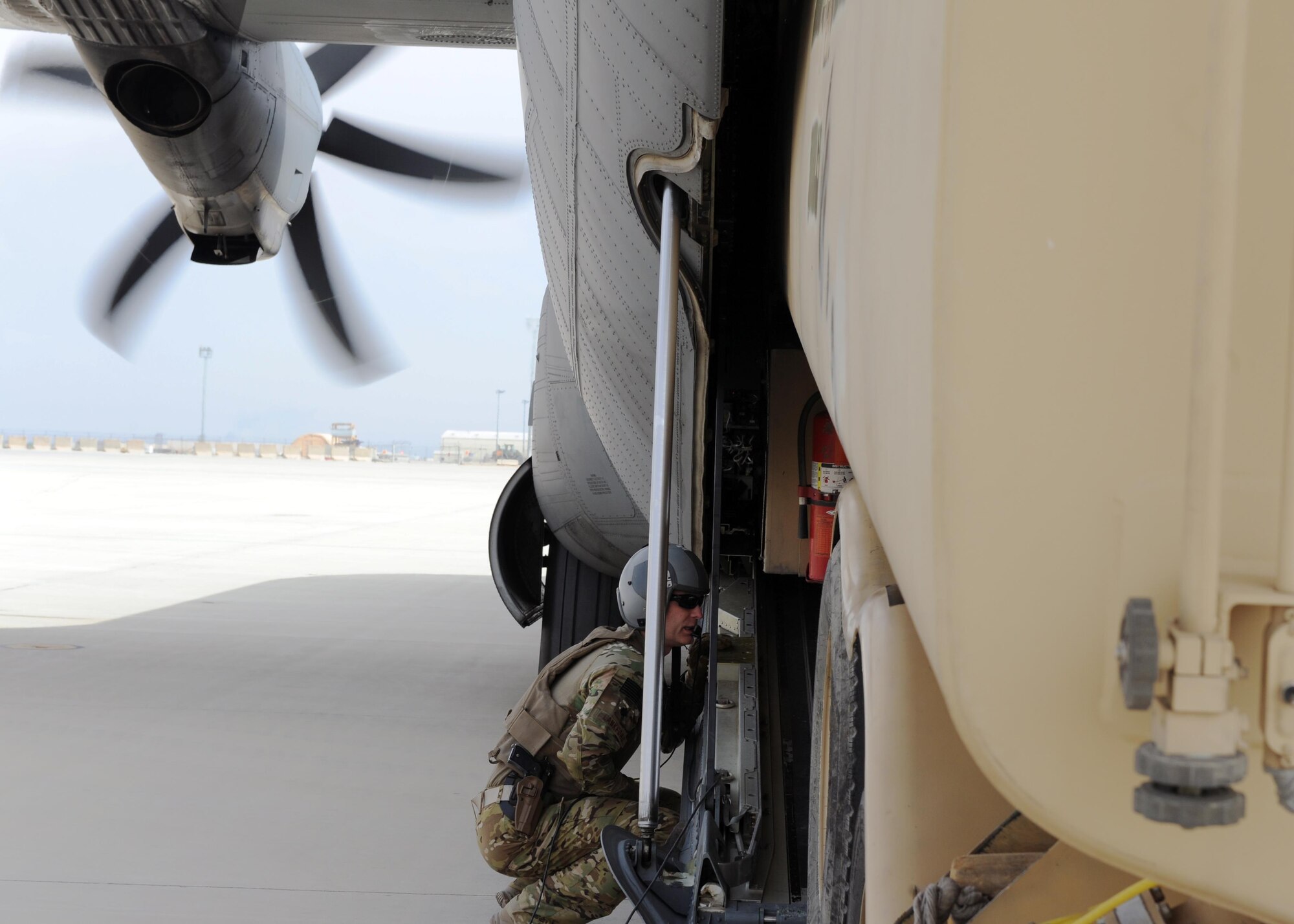 U.S. Air Force Lt. Col. Thomas Lankford, 774th Expeditionary Airlift Squadron commander, acts as a spotter as an R-11 fuel truck is loaded onto a C-130J Super Hercules aircraft during a redeployment mission at an undisclosed location in the Air Force Central Command area of responsibility March 15, 2015. The ability to forward deploy mission critical equipment, such as the R-11, to key sites throughout the AOR is more imperative than ever before as the Air Force reduces its footprint in the region. (U.S. Air Force photo by Staff Sgt. Whitney Amstutz)