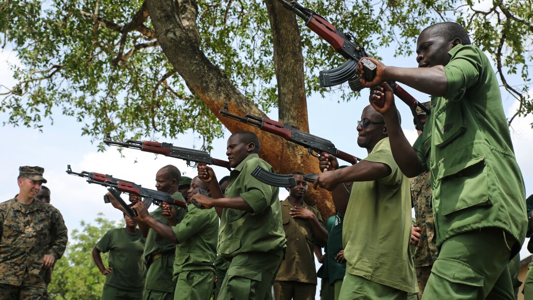 Tanzanian park rangers conduct speed reloading drills during a combat marksmanship class given by U.S. Marines with Special-Purpose Marine Air-Ground Task Force Crisis Response-Africa at the Selous Game Reserve in Matambwe, Tanzania, March 3, 2015. The Marines and Sailors with SPMAGTF-CR-AF will spend the next several weeks teaching the Tanzanian park rangers infantry skills such as patrolling, offensive tactics, land navigation and mounted operations to aid in countering illicit trafficking. 