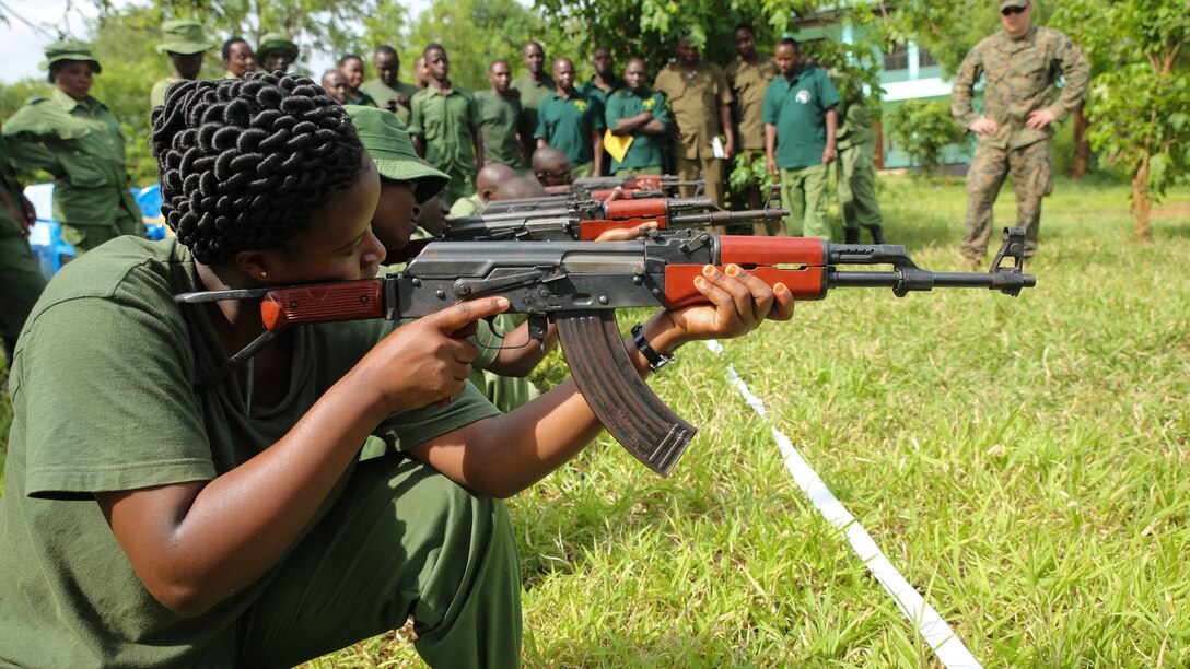 Tanzanian park rangers practice aiming their AKM assault rifles while kneeling during a combat marksmanship class given by U.S. Marines with Special-Purpose Marine Air-Ground Task Force Crisis Response-Africa aboard the Selous Game Reserve in Matambwe, Tanzania, March 3, 2015. Approximately 15 Marines and Sailors with the unit taught the park rangers infantry tactics to aid in countering illicit-trafficking. 