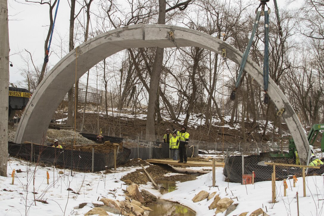 ARLINGTON, Va. – A second concrete arch is placed into position at the Arlington National Cemetery Millennium Project here March 3, 2015. The archways will support the loop road bridge, which spans a restored stream at the cemetery’s 27-acre expansion project. The project will add nearly 30,000 burial and niche spaces with a mix of above-ground columbariums and in-ground burials. (U.S. Army photo/Patrick Bloodgood)