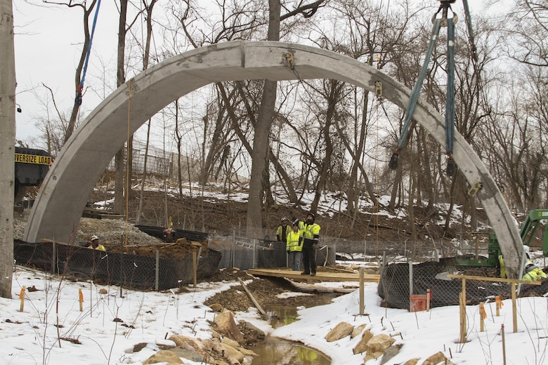 ARLINGTON, Va. – A second concrete arch is placed into position at the Arlington National Cemetery Millennium Project here March 3, 2015. The archways will support the loop road bridge, which spans a restored stream at the cemetery’s 27-acre expansion project. The project will add nearly 30,000 burial and niche spaces with a mix of above-ground columbariums and in-ground burials. (U.S. Army photo/Patrick Bloodgood)