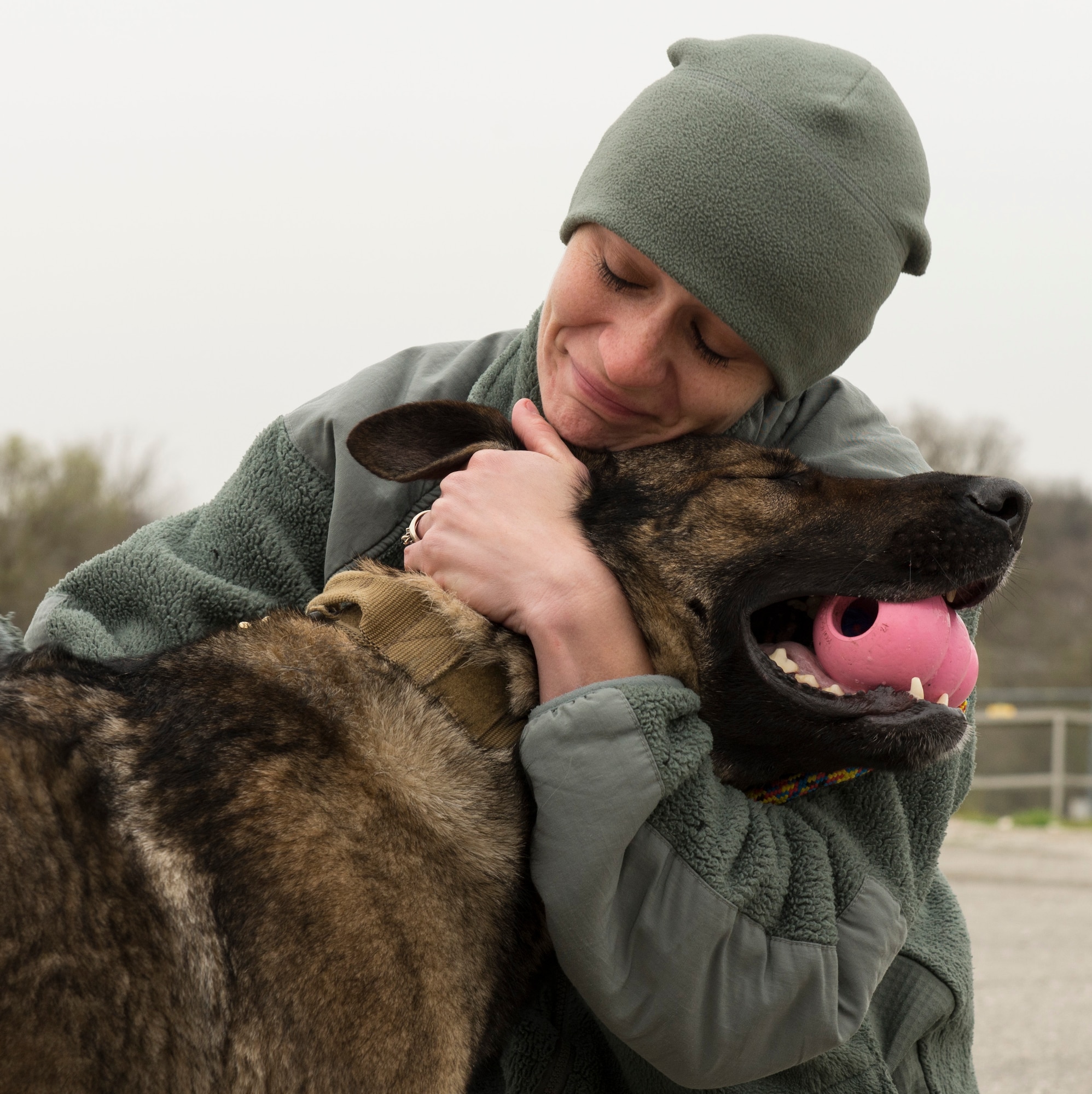 Senior Airman Chelsea LaFever, military working dog handler assigned to the 802nd Security Forces Squadron at Joint Base San Antonio-Lackland, Texas, says her final farewell to MWD Daysi, Feb. 27, 2015. (U.S. Air Force photo by Airman 1st Class Justine Rho)