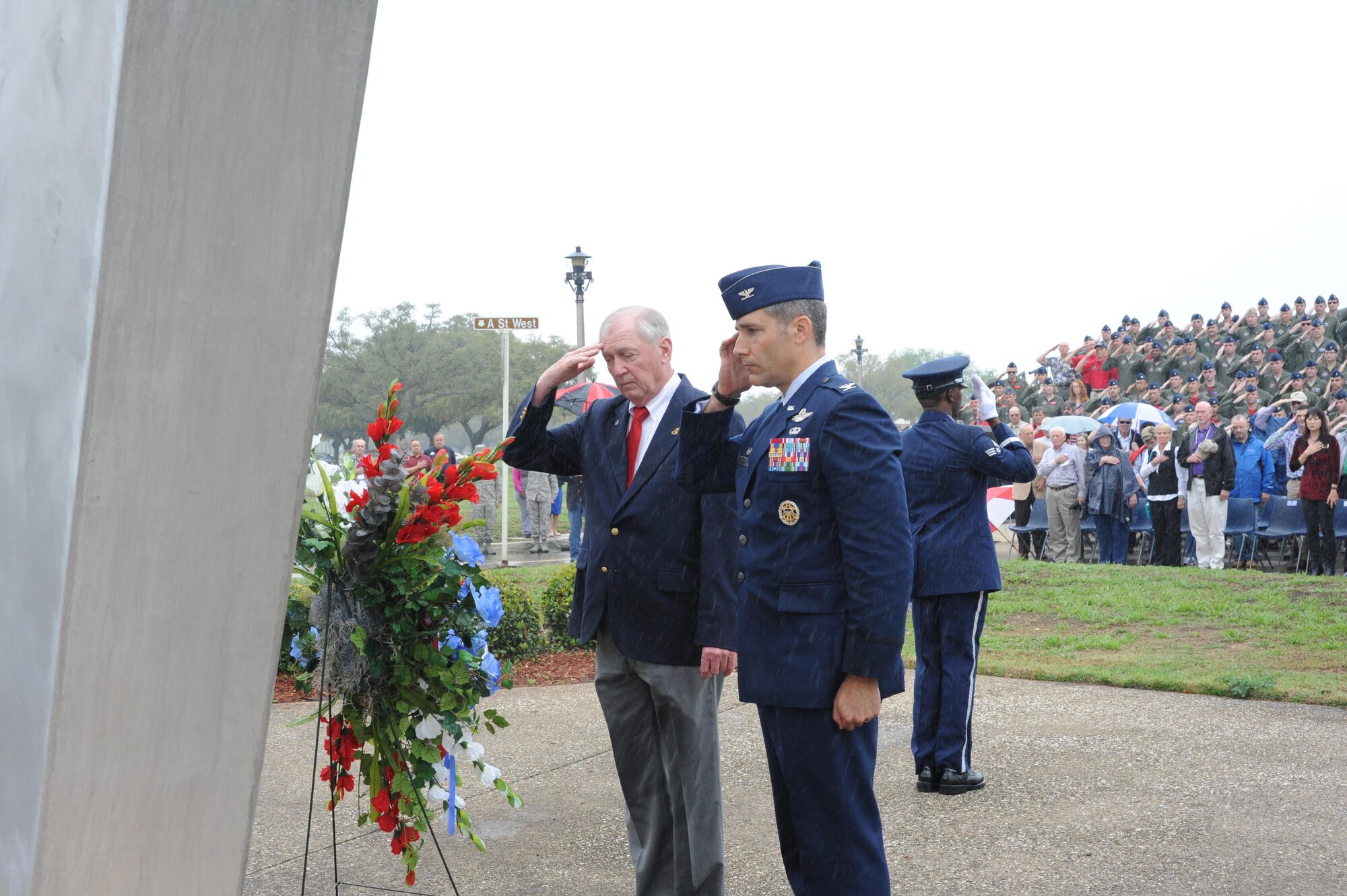 Col. Matthew Isler, 12th Flying Training Wing commander, (right) and retired Marine Lt. Col. Orson Swindle (left), whose F-8E aircraft was shot down over North Vietnam Nov. 11, 1966, salute the wreath at the Joint Base San Antonio-Randolph Missing Man Monument during a wreath laying ceremony March 20 to honor prisoners of war and those missing in action. (U.S. Air Photo by Melissa Peterson)
