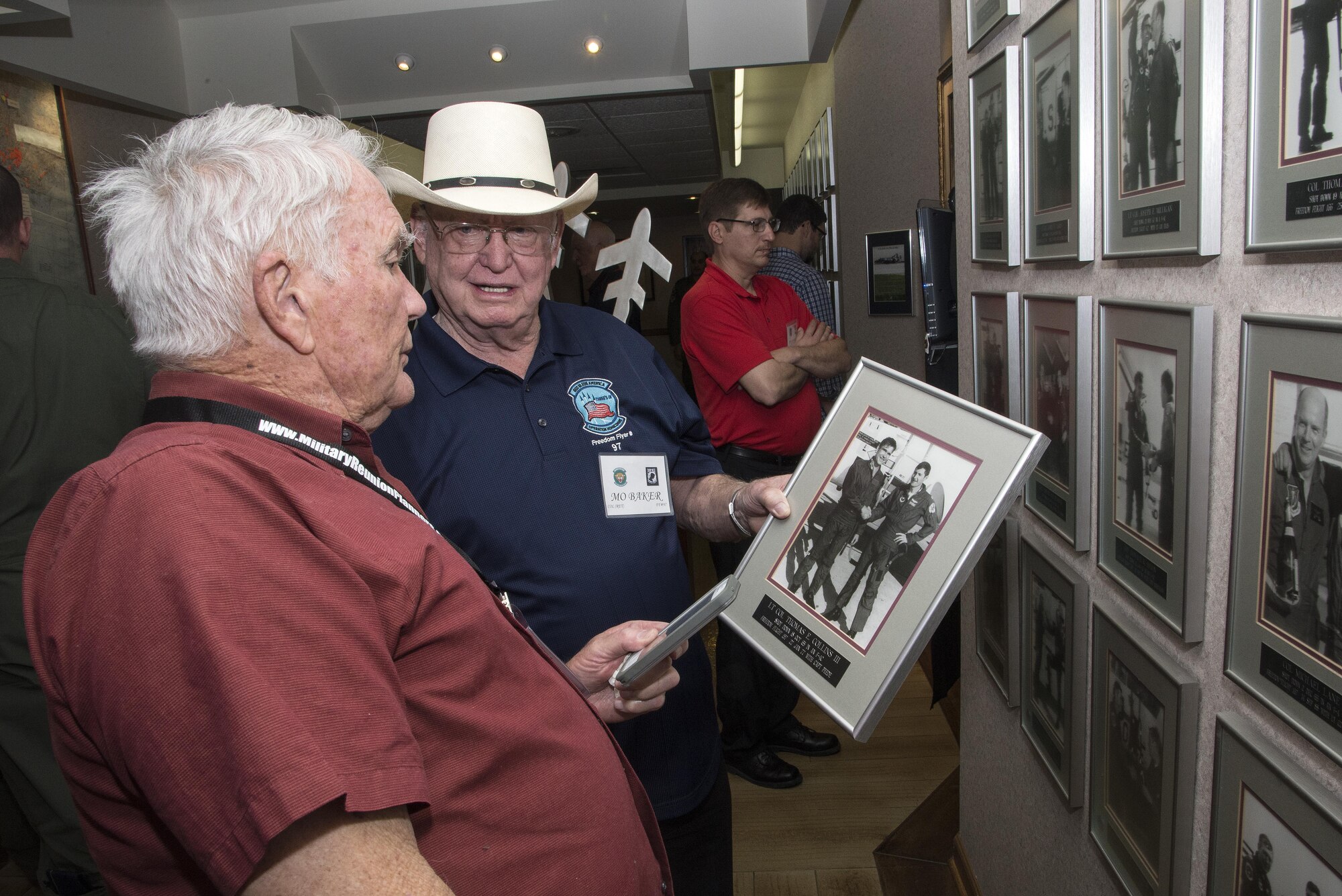 Retired Air Force Lt. Col. Thomas Collins (left), former Vietnam War POW, and retired Air Force Col. Elmo Baker, former Vietnam War POW, view Collins’ Freedom Flight photo during the 560th Flying Training Squadron Artifact Dedication ceremony and open house March 20 at Joint Base San Antonio-Randolph. The annual event, in conjunction with the 42nd Freedom Flyer Reunion and 18th Annual POW/MIA Symposium, honors all POWs held captive during the Vietnam War. The tradition began when members of the 560th Flying Training Squadron were given the task to retrain more than 150 POWs returning to flying status. Collins aircraft was shot down during a mission over North Vietnam Oct. 18, 1965, and was held captive by the North Vietnamese until his release Feb. 12, 1973. Baker’s aircraft was shot down during a mission over North Vietnam Aug. 23, 1967, and was held captive by the North Vietnamese until his release March 1973. (U.S. Air Force Photo by Johnny Saldivar)