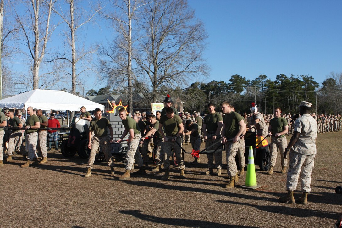 Marines from MWSS 272, 8th ESB, 2nd CEB, and MCES line up to participate in the Chariot Race event at the annual St. Patrick’s Day Engineer Field Meet, on Ellis Field, aboard Marine Corps Base Camp Lejeune, North Carolina, March 12, 2015.