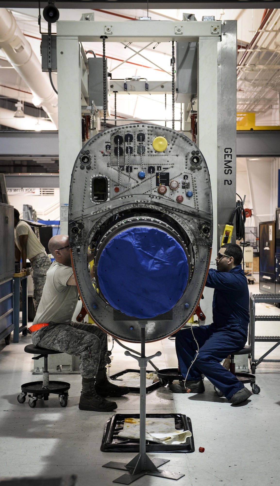 Aerospace propulsion journeymen from the 1st Special Operations Component Maintenance Squadron, route oil lines through an engine at the Centralized Repair Facility, Hurlburt Field, Fla., Feb. 3, 2015. The Centralized Repair Facility is responsible for building and repairing T-56 engines and C-130 propellers. (U.S. Air Force photo Senior Airman Meagan Schutter/Released)