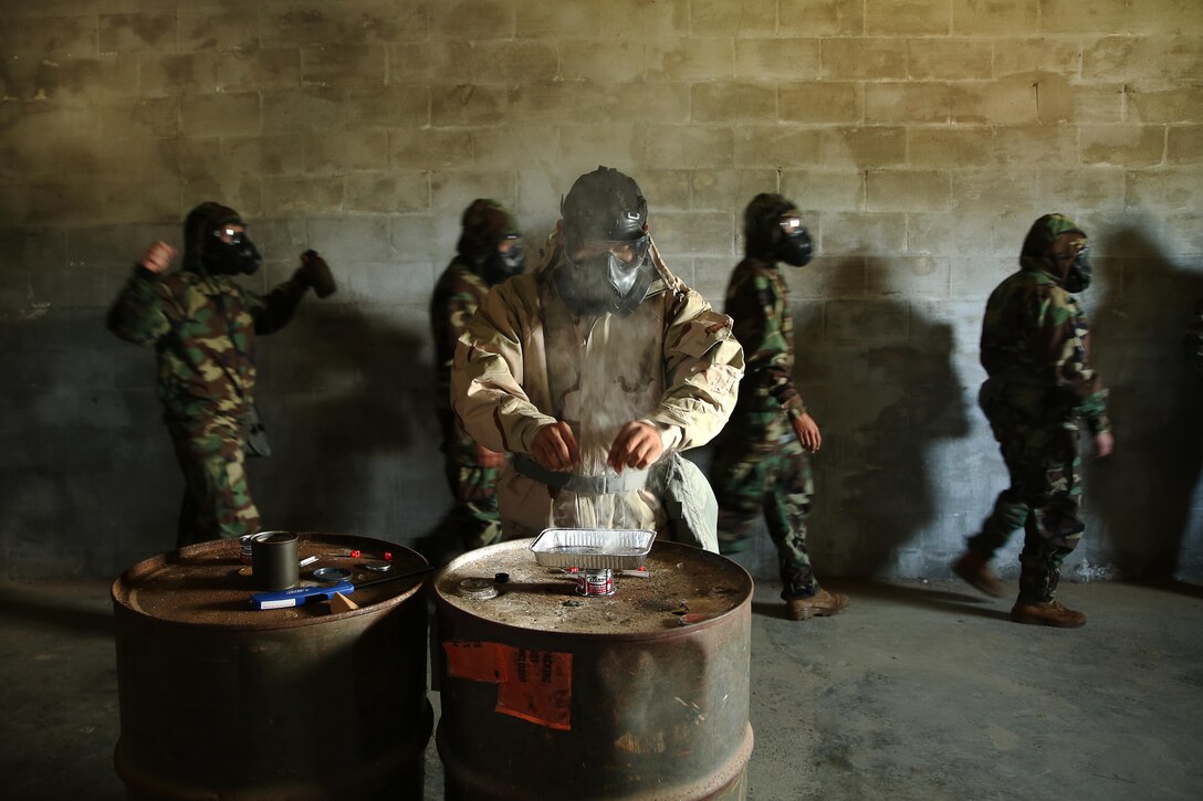 Sgt. Carlos Iruegas, U.S. Marine Corps Forces, Pacific chemical, biological, radiological and nuclear defense chief, prepares the CS gas (tear gas) at the gas chamber aboard Marine Corps Base Hawaii March 19, 2015. Gas chamber training is part of an annual training requirement for Marines.