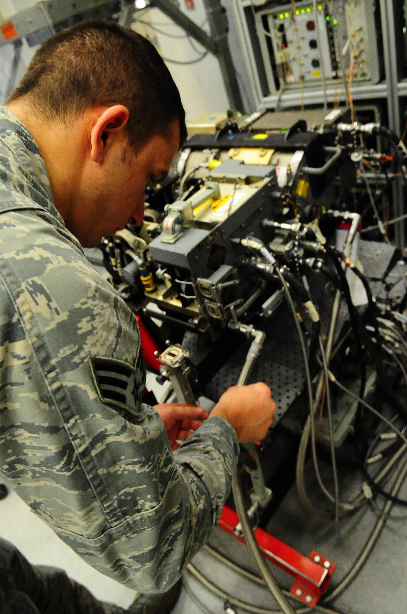 Senior Airman Nicholas Siegler, 1st Special Operations Component Maintenance Squadron journeyman mission systems avionics technician, checks transmitter wires at Hurlburt Field Fla., March 3, 2015. The 1st SOCMS provides command-wide, organizational and intermediate-level repair capability for a variety of aircraft. (U.S. Air Force photo/Airman 1st Class Andrea Posey)