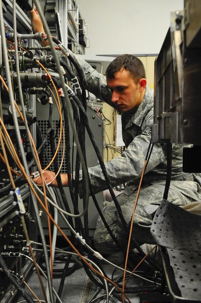 Senior Airman Nicholas Siegler, 1st Special Operations Component Maintenance Squadron journeyman mission systems avionics technician, checks signal wires from a transmitter test station at Hurlburt Field Fla., March 3, 2015. The 1st SOCMS provides command-wide, organizational and intermediate-level repair capability for a variety of aircraft. (U.S. Air Force photo/Airman 1st Class Andrea Posey)