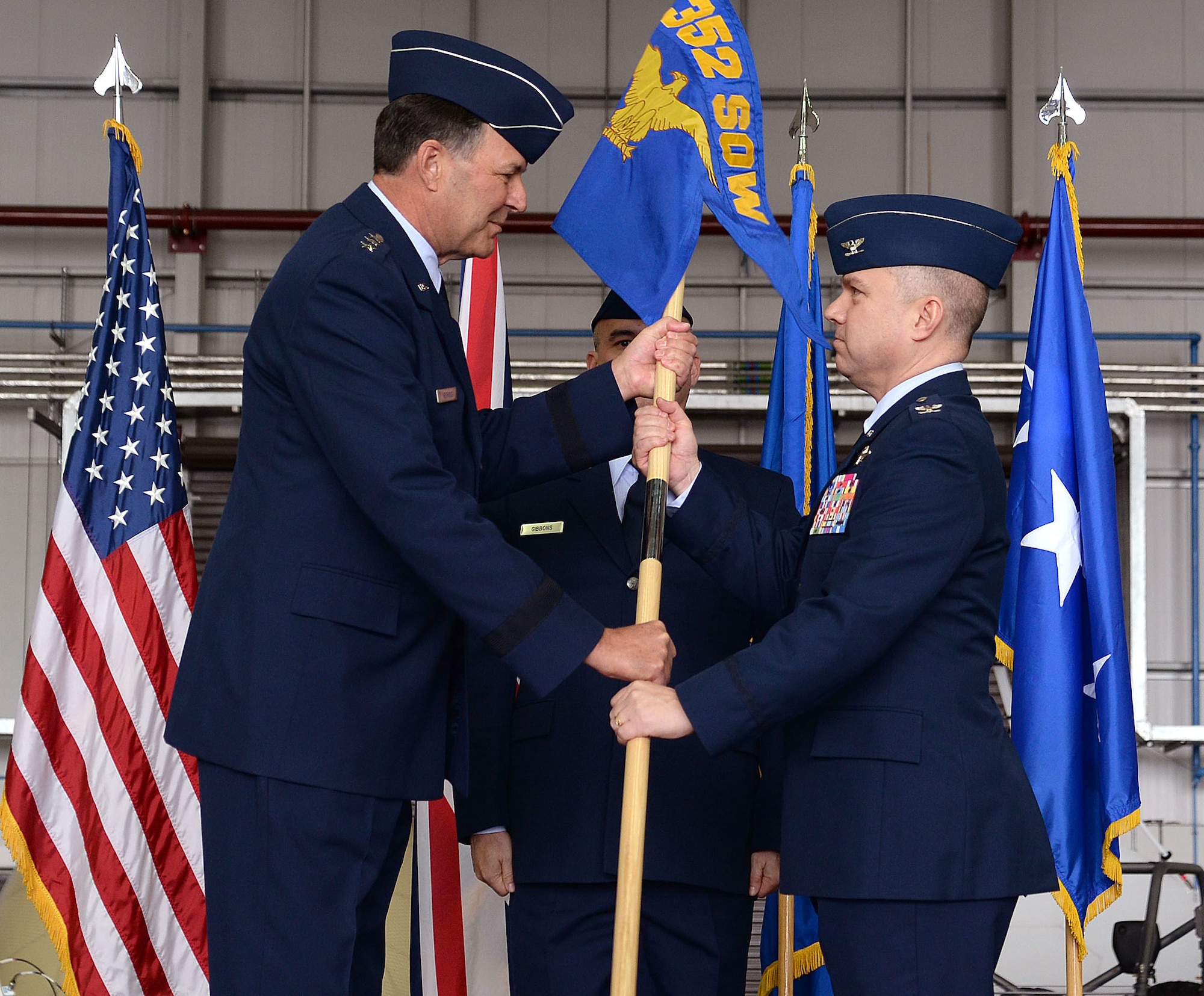 U.S. Air Force Lt. Gen. Brad A. Heithold, left, Air Force Special Operations Command commander, passes the 352nd Special Operations Wing guidon to U.S. Air Force Col. William Holt, 352nd SOW commander, during the 352nd SOW activation ceremony, March 23, 2015, on RAF Mildenhall, England. The 352nd SOW is responsible for planning and executing specialized and contingency operations using advanced aircraft, tactics and air refueling techniques to infiltrate, exfiltrate and resupply special operations forces.  (U.S. Air Force photo by Senior Airman Christine Griffiths)