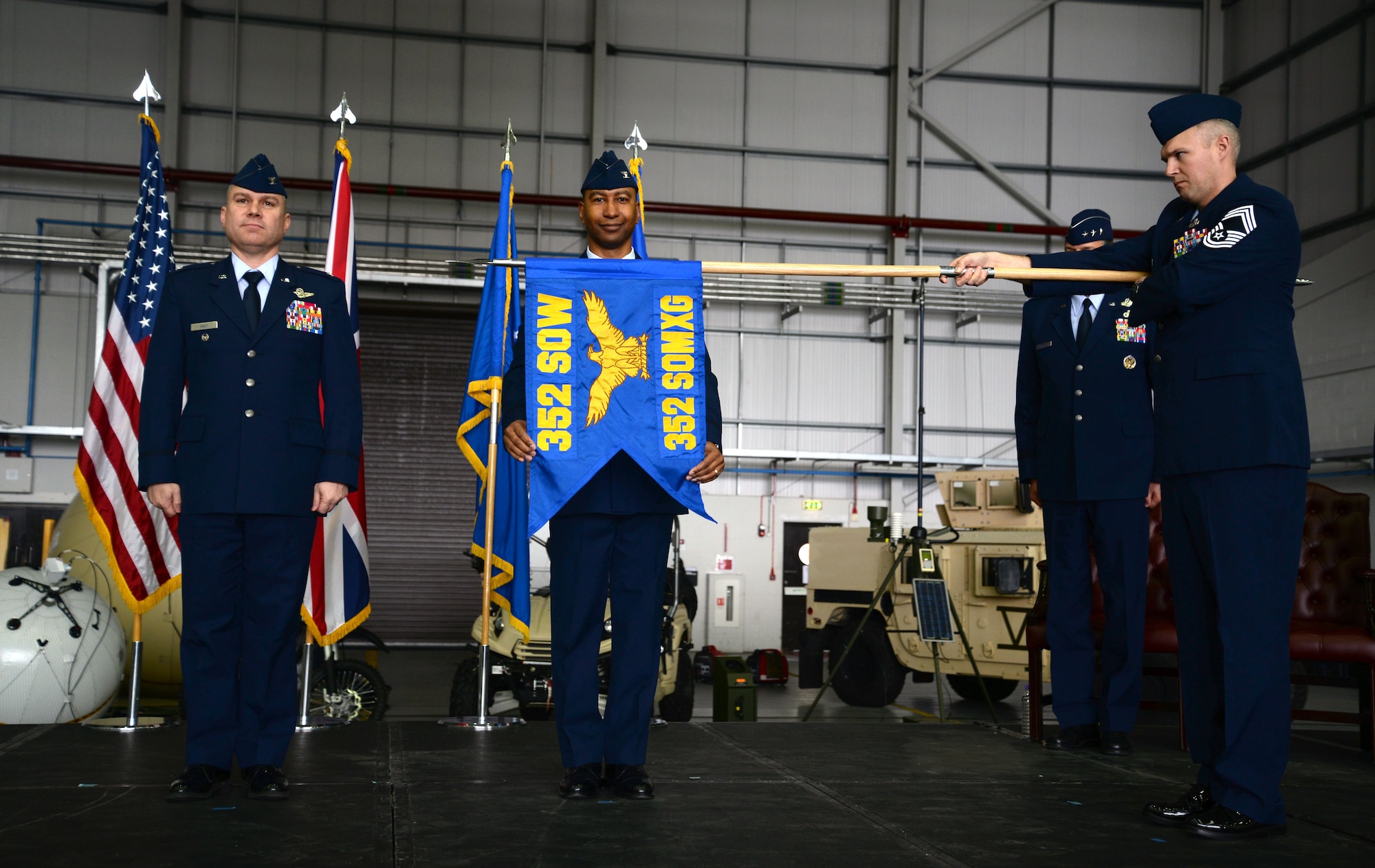 U.S. Air Force Col. Eric Faison, 352nd Special Operations Maintenance Group commander, poses after unravelling the 352nd SOMXG flag during the 352nd Special Operations Wing activation ceremony March 23, 2015, on RAF Mildenhall, England. (U.S. Air Force photo by Senior Airman Christine Griffiths)