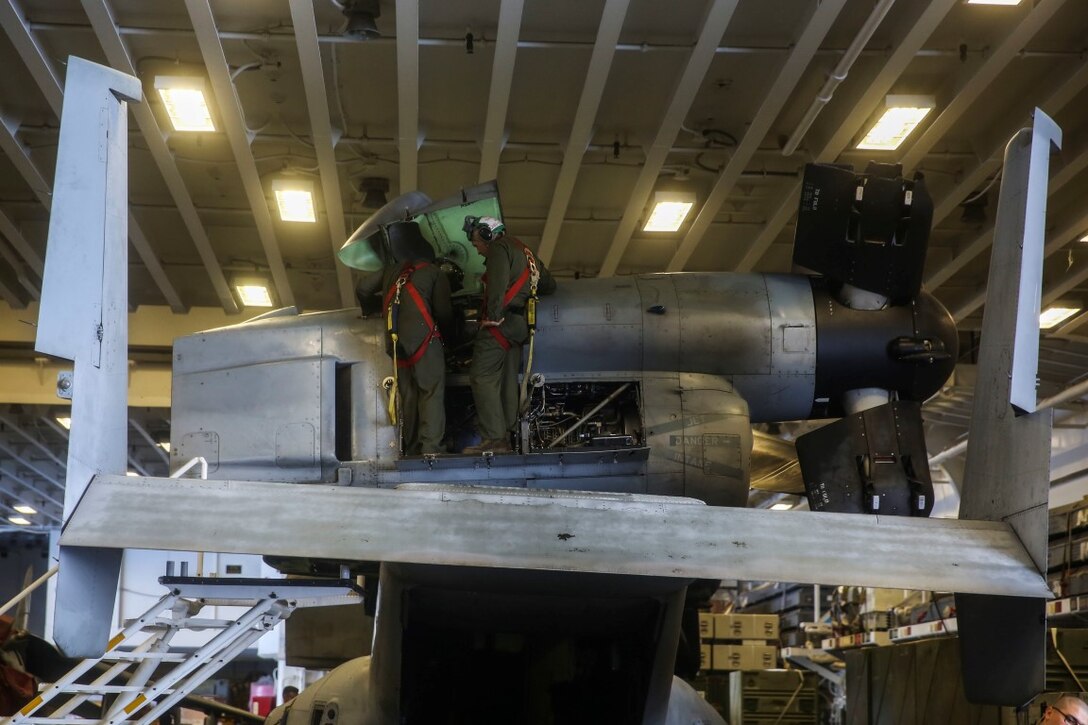 U.S. Marines with Marine Medium Tiltrotor Squadron 161 (Reinforced) perform maintenance on a MV-22 Osprey aboard the USS Essex (LHD 2) during Composite Training Unit Exercise (COMPTUEX) March 20, 2015. During COMPTUEX, Marines with the 15th Marine Expeditionary Unit and Sailors with the Essex Amphibious Ready Group worked together to plan and execute different scenarios they may face during deployment. (U.S. Marine Corps photo by Cpl. Anna Albrecht/Released)