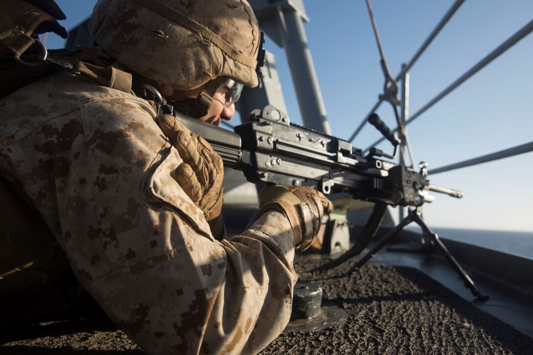 U.S. Marine Lance Cpl. Jaime Camacho provides security during small-craft action team rehearsals aboard the USS Rushmore (LSD 47) during Composite Training Unit Exercise (COMPTUEX) off the coast of San Diego March 21, 2015. Camacho is an automatic rifleman with Kilo Company, Battalion Landing Team 3rd Battalion, 1st Marine Regiment, 15th Marine Expeditionary Unit. SCAT is an on-call team of Marines and Sailors trained to use various crew-served weapons to defend the ship when there is a limited distance to respond. (U.S. Marine Corps photo by Sgt. Emmanuel Ramos/Released)