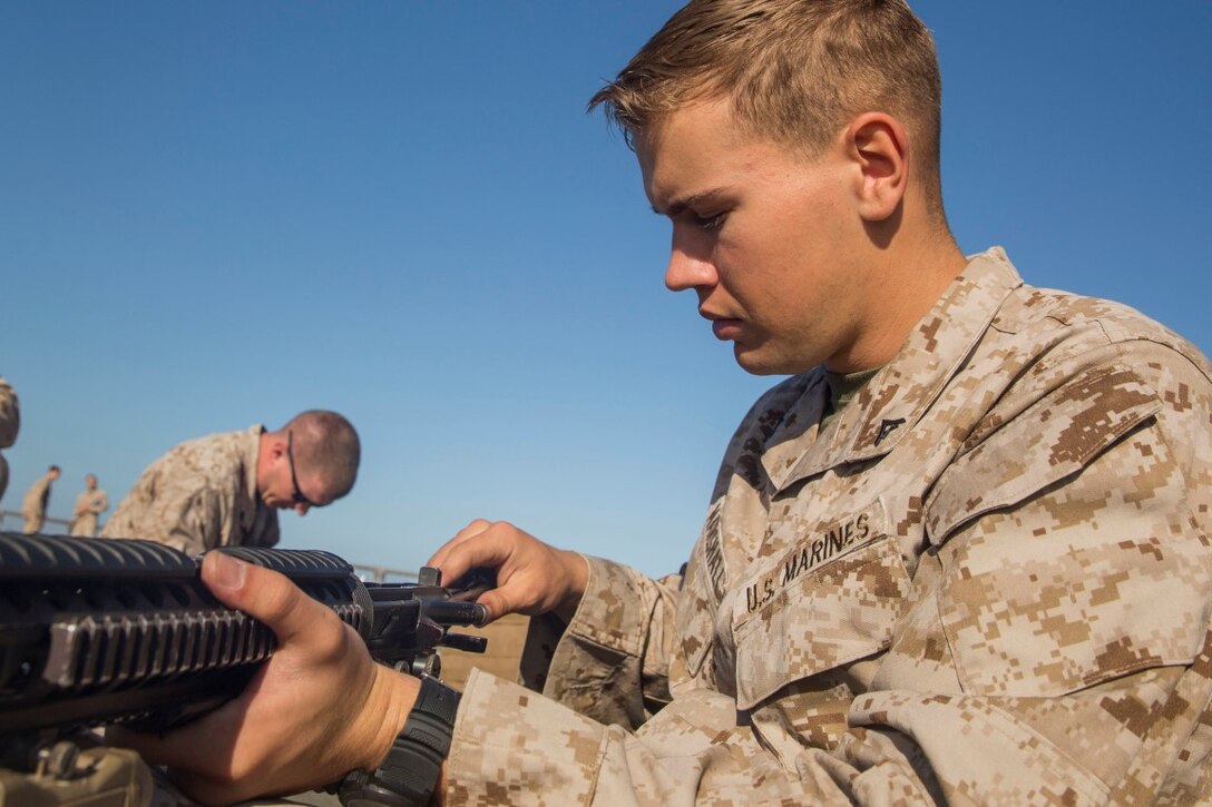 U.S. Marine Lance Cpl. Jared Marshall pulls the bolt out of his M16A4 rifle aboard the USS Rushmore (LSD 47), during Composite Training Unit Exercise (COMPTUEX) off the coast of San Diego March 21, 2015. Marshall is a radio operator with Kilo Company, Battalion Landing Team 3rd Battalion, 1st Marine Regiment, 15th Marine Expeditionary Unit. Marines must maintain a state of readiness by making sure weapons are cleaned. (U.S. Marine Corps photo by Sgt. Emmanuel Ramos/Released)