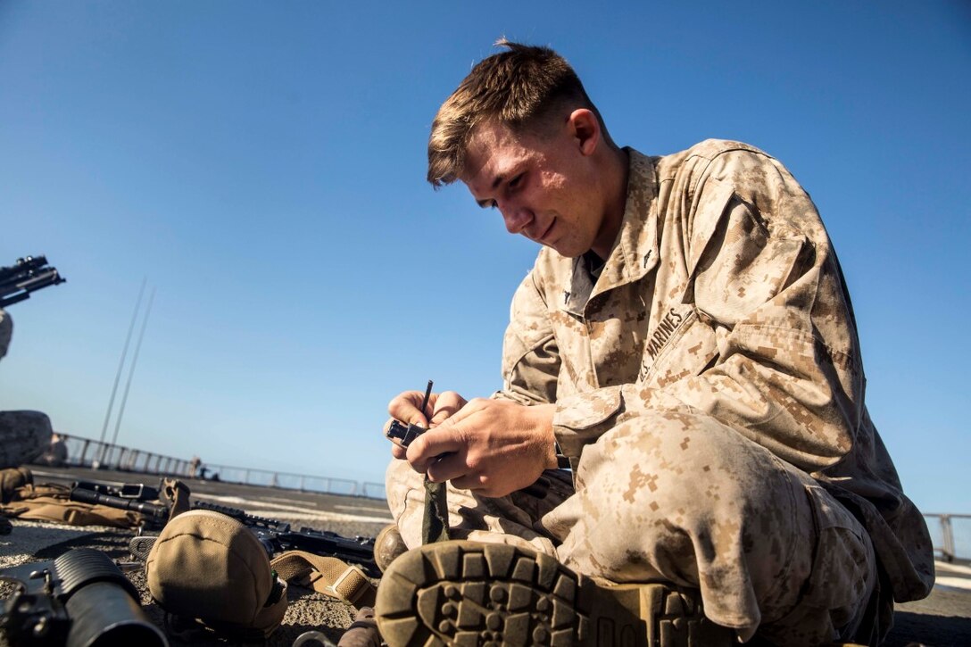 U.S. Marine Lance Cpl. Ian Forry cleans the bolt to his M4 carbine aboard the USS Rushmore (LSD 47) during Composite Training Unit Exercise (COMPTUEX) off the coast of San Diego March 21, 2015. Forry is a team leader with Kilo Company, Battalion Landing Team 3rd Battalion, 1st Marine Regiment, 15th Marine Expeditionary Unit. While on ship, Marines focus on maintaining their weapons and combat skills. (U.S. Marine Corps photo by Sgt. Emmanuel Ramos/Released)