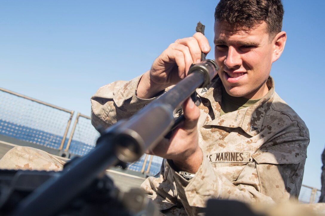 U.S. Marine Lance Cpl. Edward O’Reilly cleans the barrel to an M249 squad automatic weapon aboard the USS Rushmore (LSD 47) during Composite Training Unit Exercise (COMPTUEX) off the coast of San Diego March 21, 2015. O’Reilly is an automatic rifleman with Kilo Company, Battalion Landing Team 3rd Battalion, 1st Marine Regiment, 15th Marine Expeditionary Unit. Marines must maintain a state of readiness by making sure weapons are cleaned. (U.S. Marine Corps photo by Sgt. Emmanuel Ramos/Released)