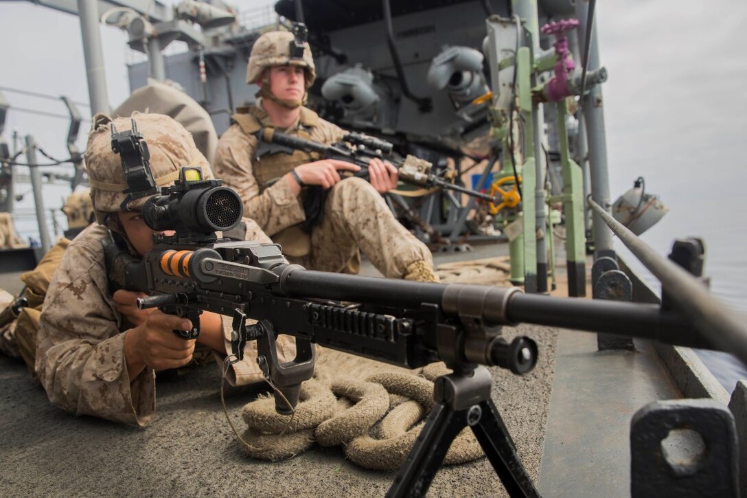 U.S. Marines Lance Cpl. Jalen Freiberg, left, and Lance Cpl. Nicholas Keniston provides security during small craft action team rehearsals aboard the USS Rushmore (LSD 47), during Composite Training Unit Exercise (COMPTUEX) off the coast of San Diego March 21, 2015. Ferguson is a rifleman with Kilo Company, Battalion Landing Team 3rd Battalion, 1st Marine Regiment, 15th Marine Expeditionary Unit. SCAT is an on-call team of Marines and Sailors trained to use various crew-served weapons to defend the ship when there is a limited distance to respond. (U.S. Marine Corps photo by Sgt. Emmanuel Ramos/Released)