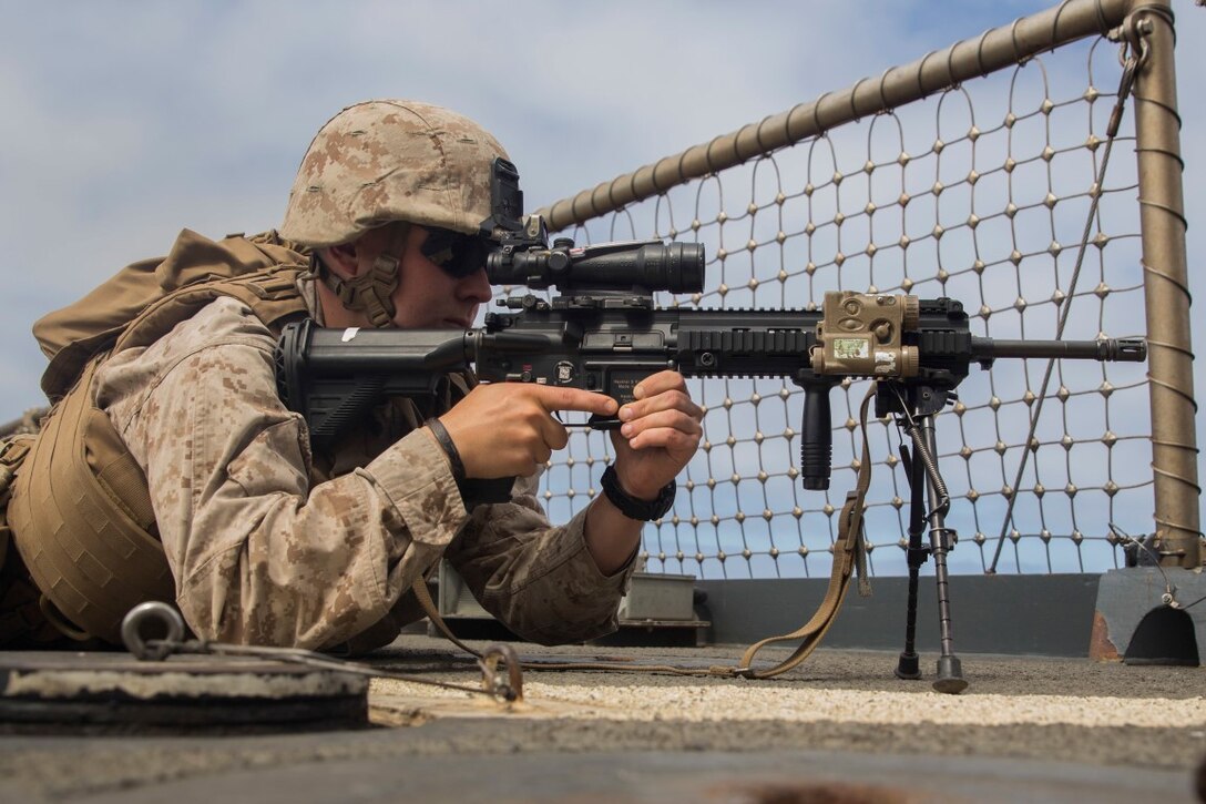 U.S. Marine Lance Cpl. Dmitriy Nikolayenko provides security during small craft action team rehearsals aboard the USS Rushmore (LSD 47), during Composite Training Unit Exercise (COMPTUEX) off the coast of San Diego March 21, 2015. Nikolayenko is an automatic rifleman with Kilo Company, Battalion Landing Team 3rd Battalion, 1st Marine Regiment, 15th Marine Expeditionary Unit. SCAT is an on-call team of Marines and Sailors trained to use various crew-served weapons to defend the ship when there is a limited distance to respond. (U.S. Marine Corps photo by Sgt. Emmanuel Ramos/Released)