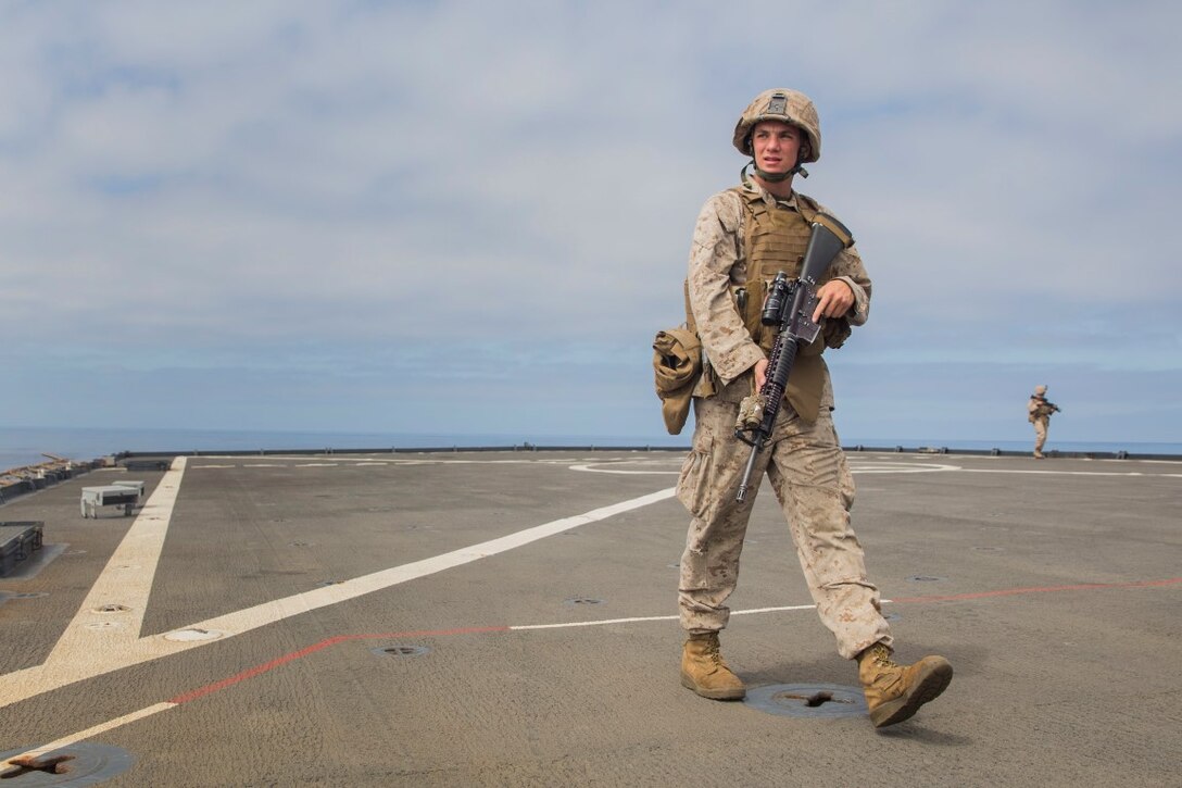 U.S. Marine Lance Cpl. Ryan Huerta provides security during small craft action team rehearsals aboard the USS Rushmore (LSD 47), during Composite Training Unit Exercise (COMPTUEX) off the coast of San Diego March 21, 2015. Huerta is a rifleman with Kilo Company, Battalion Landing Team 3rd Battalion, 1st Marine Regiment, 15th Marine Expeditionary Unit. SCAT is an on-call team of Marines and Sailors trained to use various crew-served weapons to defend the ship when there is a limited distance to respond. (U.S. Marine Corps photo by Sgt. Emmanuel Ramos/Released)
