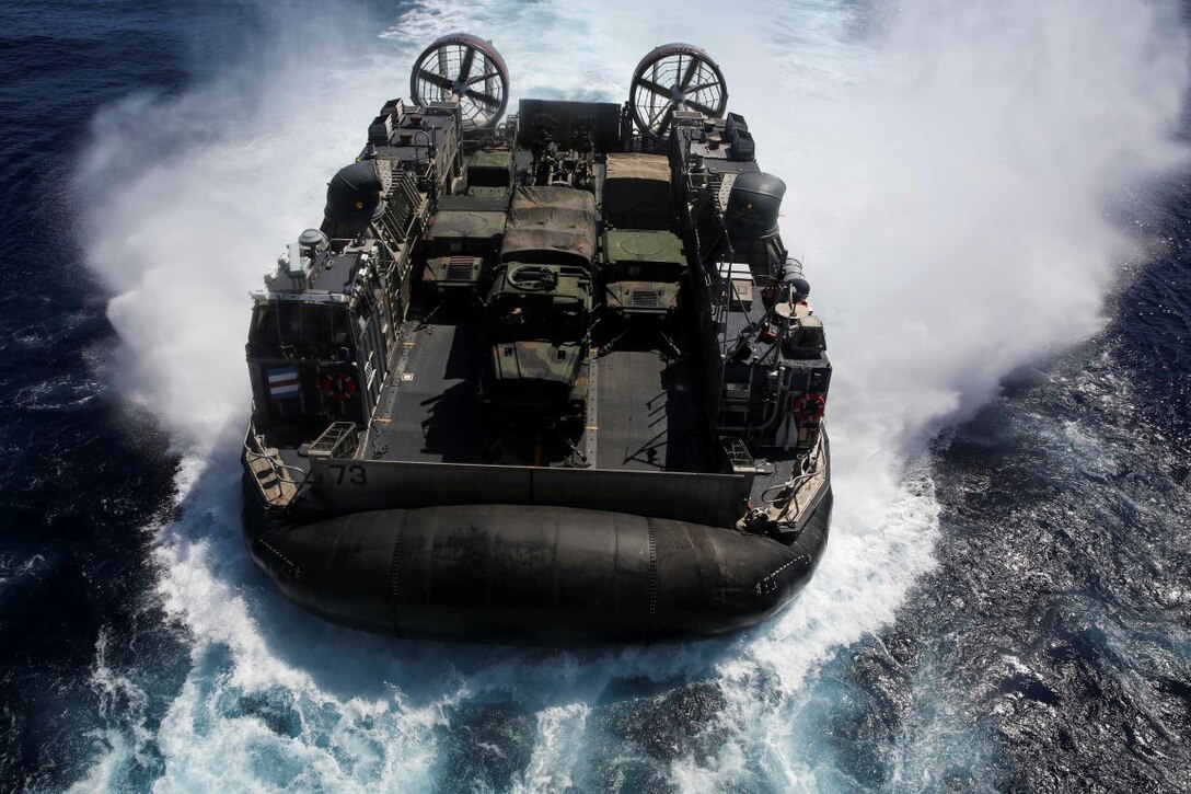 U.S. Navy Landing Craft, Air Cushion 73 with Assault Craft Unit 5, prepares to enter the USS Essex (LHD 2) during Composite Training Unit Exercise (COMPTUEX) off the coast of San Diego March 21, 2015. Aboard the LCAC were U.S. Marines with Battalion Landing Team 3rd Battalion, 1st Marine Regiment, 15th Marine Expeditionary Unit, after training aboard San Clemente Island, Calif. (U.S. Marine Corps photo by Cpl. Anna Albrecht/Released)