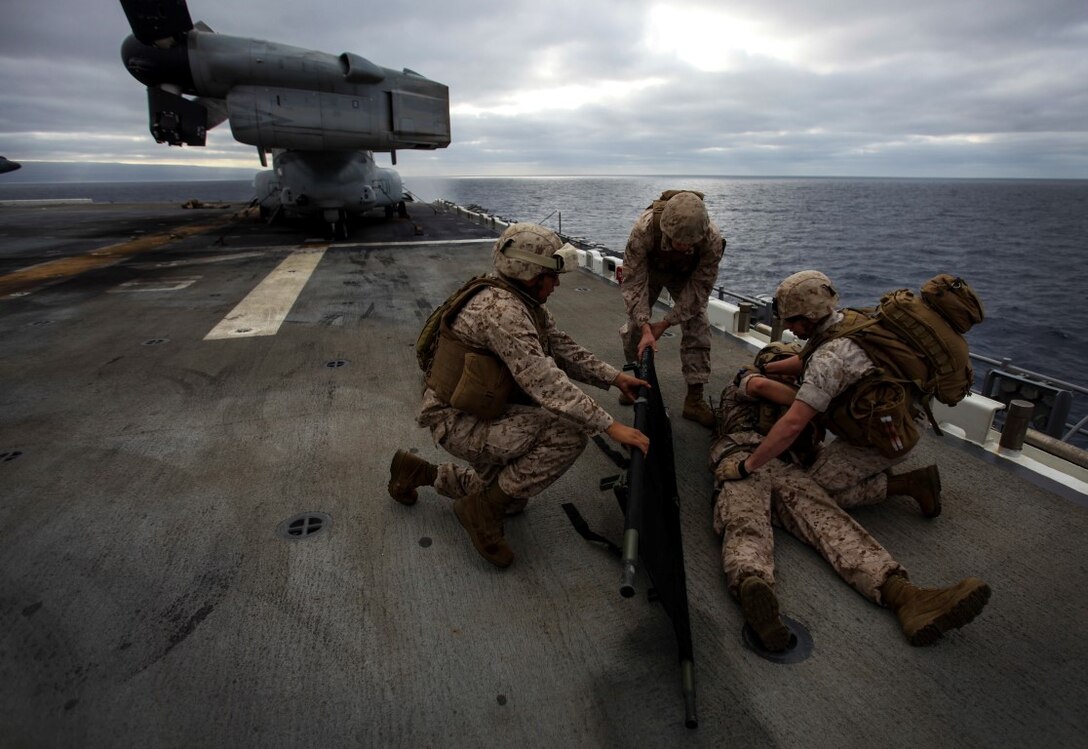U.S. Marines with Combat Logistics Battalion 15, 15th Marine Expeditionary Unit, lift a simulated casualty onto a stretcher during a mass casualty drill as part of Composite Training Unit Exercise (COMPTUEX) aboard the USS Essex (LDH 2) off the coast of San Diego March 22, 2014. CLB-15 is the MEU’s logistics combat element and provides both routine and emergency combat medical care for the more than 2,200 Marines. (U.S. Marine Corps photo by Cpl. Elize McKelvey/Released)