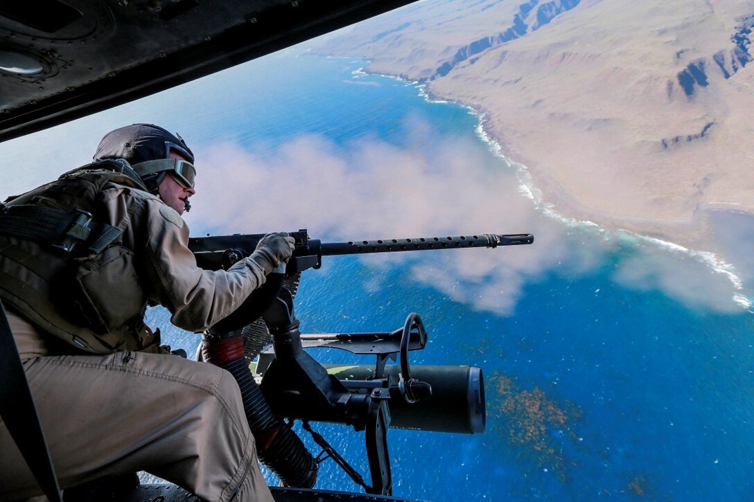 A U.S. Marine engages targets from a UH-1Y Venom with Marine Medium Tiltrotor Squadron 161 (Reinforced), 15th Marine Expeditionary Unit, during Composite Training Unit Exercise (COMPTUEX) above San Clemente Island, Calif., March 20, 2015. COMPTUEX gives the Marines of VMM-161 (Rein) the opportunity to practice real-world scenarios and hone their skill sets. (U.S. Marine Corps photo by Sgt. Jamean Berry/Released)