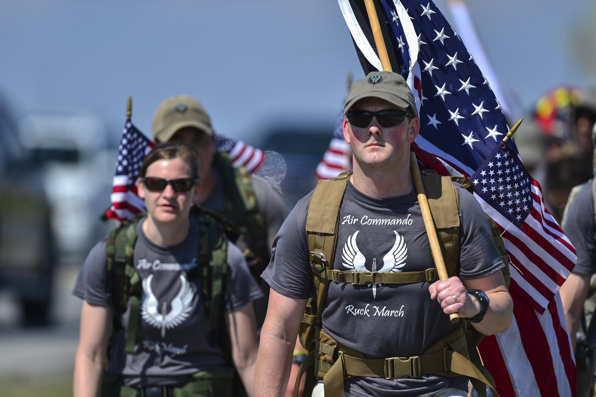 Tech Sgt. Joe Scobey, 18th Flight Test Squadron special missions aviator, leads Air Commando Ruckers to the finish line at Hurlburt Field, Fla., March 20, 2014. The Air Commando Ruckers completed a 450-mile ruck march from MacDill Air Force Base, Fla. carrying flags with the names of the seven fallen Marine Special Operations Command members and four Army National Guard members who lost their lives during a training mission on Eglin Range, Fla.(U.S. Air Force photo/Airman 1st Class Jeff Parkinson)