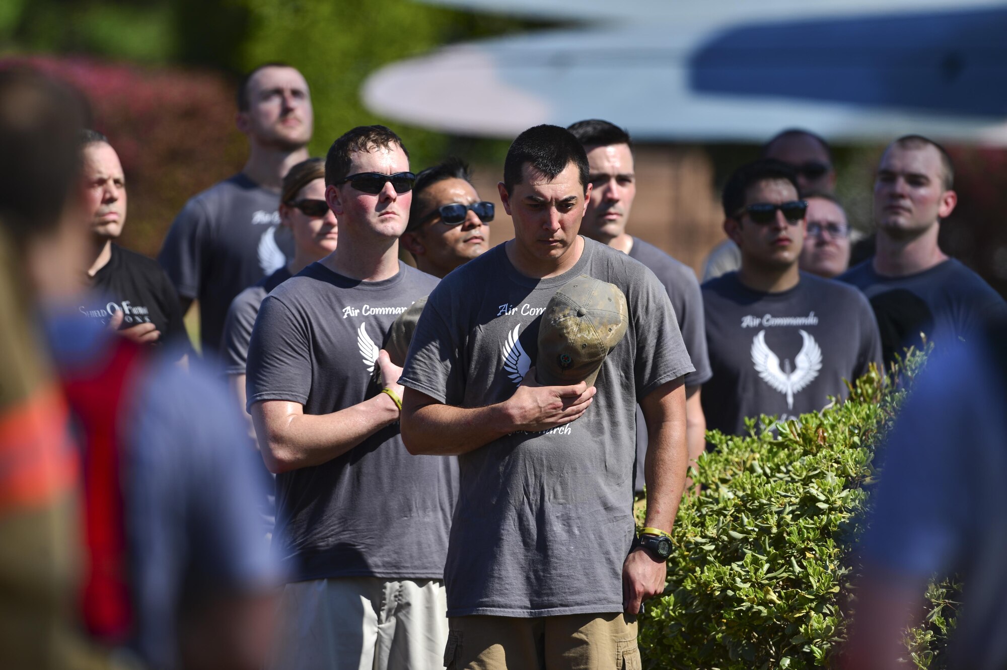 Air Commando Ruckers pay their respects during a moment of silence at Hurlburt Field, Fla., March 20, 2014. The Air Commando Ruckers carried flags with the names of the seven fallen Marine Special Operations Command members and four Army National Guard members 450 miles from MacDill Air Force Base to Hurlburt Field. (U.S. Air Force photo/Airman 1st Class Jeff Parkinson)