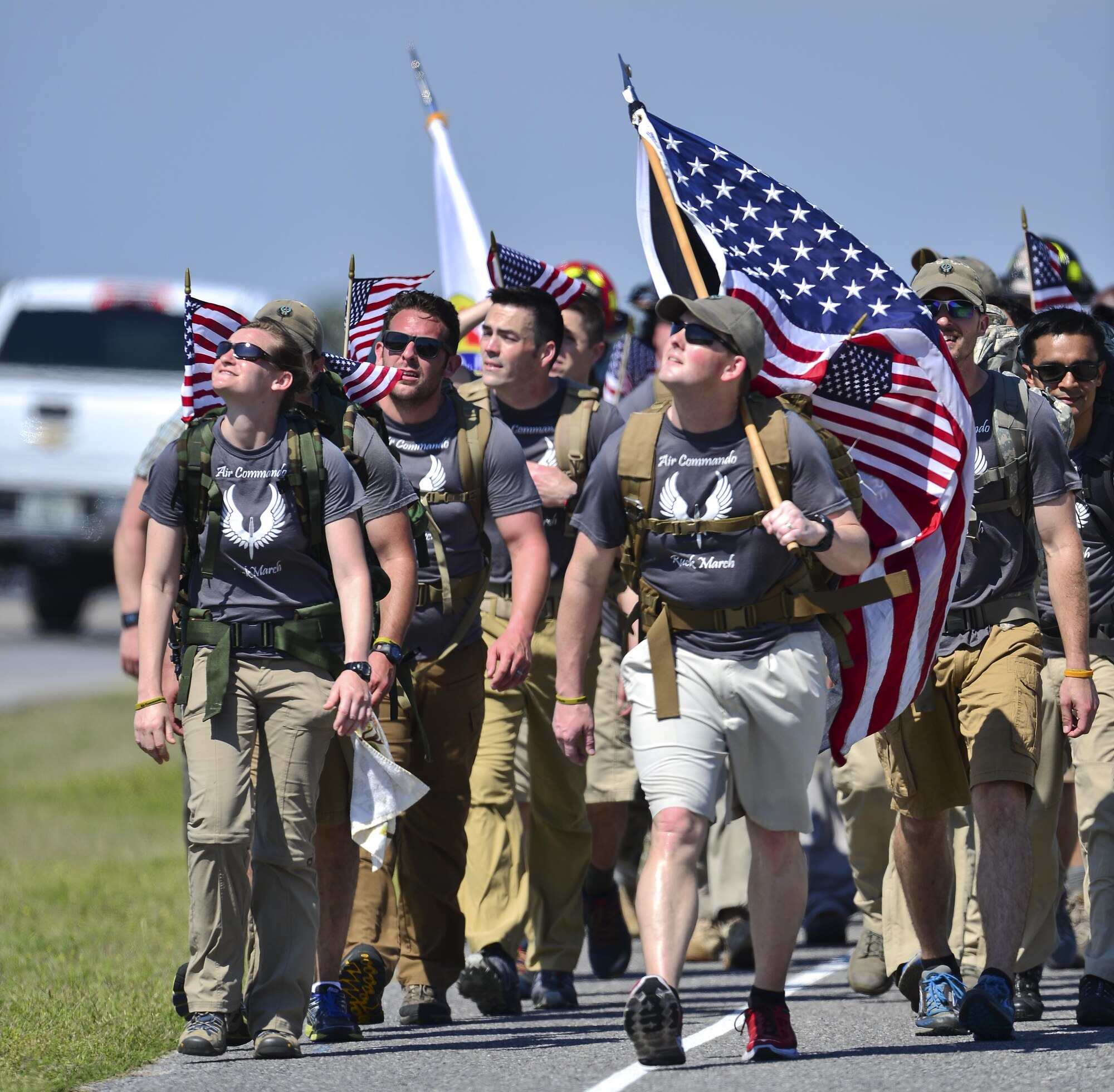 Air Commando Ruckers look at an aircraft on Hurlburt Field, Fla., March 20, 2014. The Air Commando Ruckers carried flags with the names of the seven fallen Marine Special Operations Command members and four Army National Guard members during a 450-mile ruck march from MacDill Air Force Base, Fla. to Hurlburt Field. (U.S. Air Force photo/Airman 1st Class Jeff Parkinson)