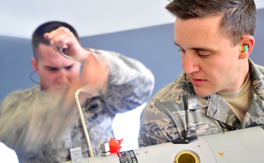 Senior Airman Jeffrey Salyer, 432nd Aircraft Maintenance Squadron weapons load crew member, helps Staff Sgt. Jason Sandlin, 432nd AMXS weapons team chief, assemble an inert GBU-12 Paveway II laser guided bomb on an MQ-9 Reaper during the 432nd Maintenance Group Load Crew of the Year competition Feb. 13, 2015, at Creech Air Force Base, Nevada. The 432nd AMXS participated in the Load Crew of the Year competition by pitting Tiger Aircraft Maintenance Unit against Reaper AMU with Reaper taking the victory. Salyer and Sandlin are both assigned to the Reaper AMU. (U.S. Air Force photo by Airman 1st Class Christian Clausen/Released)