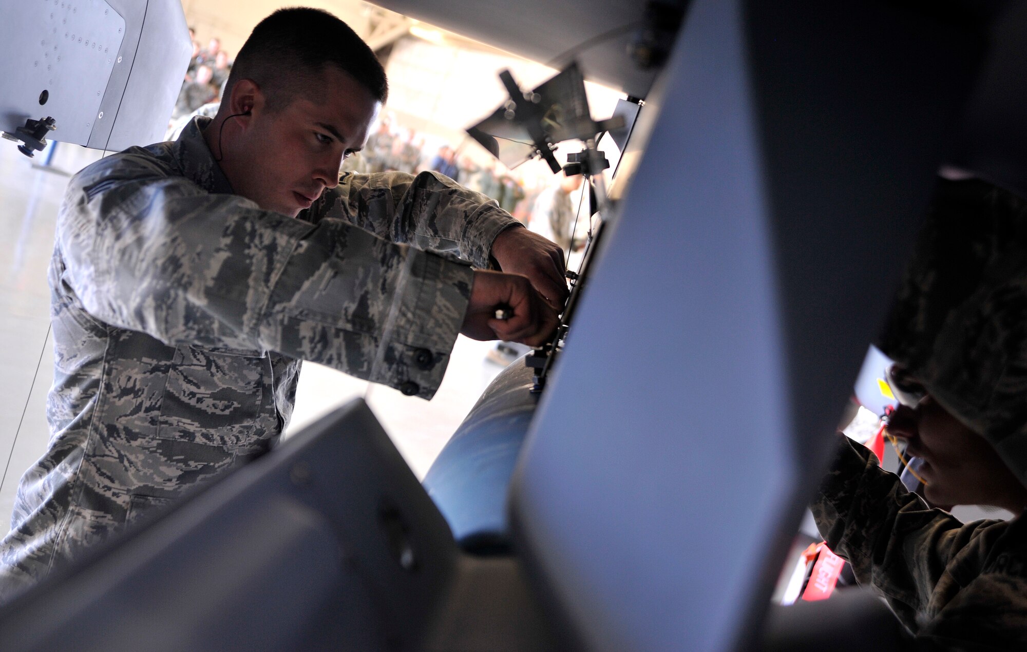 Staff Sgt. Jason Sandlin, 432nd Aircraft Maintenance Squadron weapons team chief, finishes installing an inert GBU-12 Paveway II laser guided bomb on an MQ-9 Reaper during the 432nd Maintenance Group Load Crew of the Year competition Feb. 13, 2015, at Creech Air Force Base, Nevada. Sandlin is assigned to the Reaper Aircraft Maintenance Unit and lead his team to victory in the annual competition. (U.S. Air Force photo by Airman 1st Class Christian Clausen/Released) 

