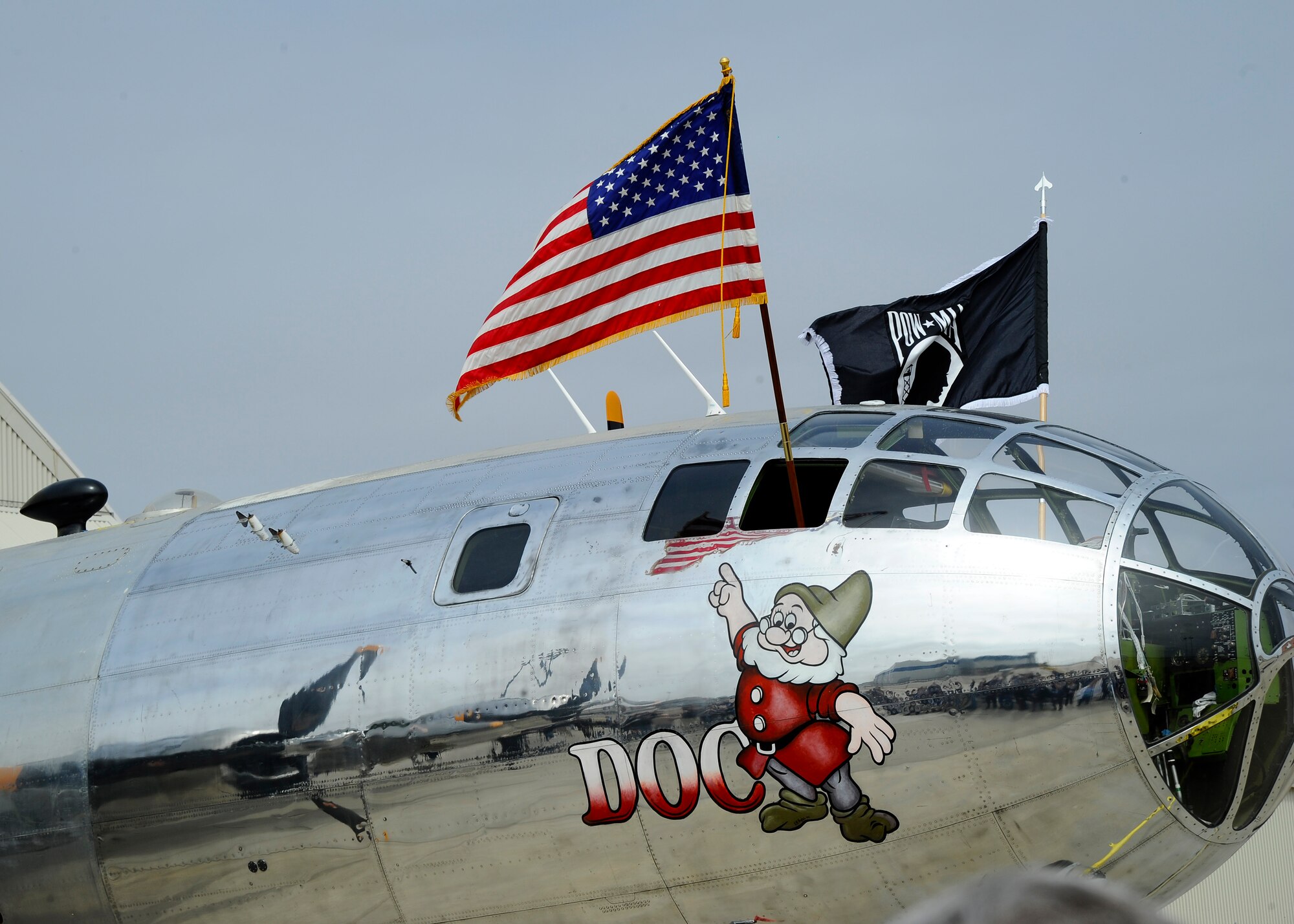 Airmen from the 22nd Air Refueling Wing Honor Guard stand at parade rest as a B-29 Superfortress is towed out of a hangar, March 23, 2015, in Wichita, Kan. This B-29, named Doc after its nose art, will be one of two Superfortresses in the world capable of flying. Volunteers have spent more than 300,000 hours restoring the aircraft. (U.S. Air Force photo by Senior Airman Victor J. Caputo)
