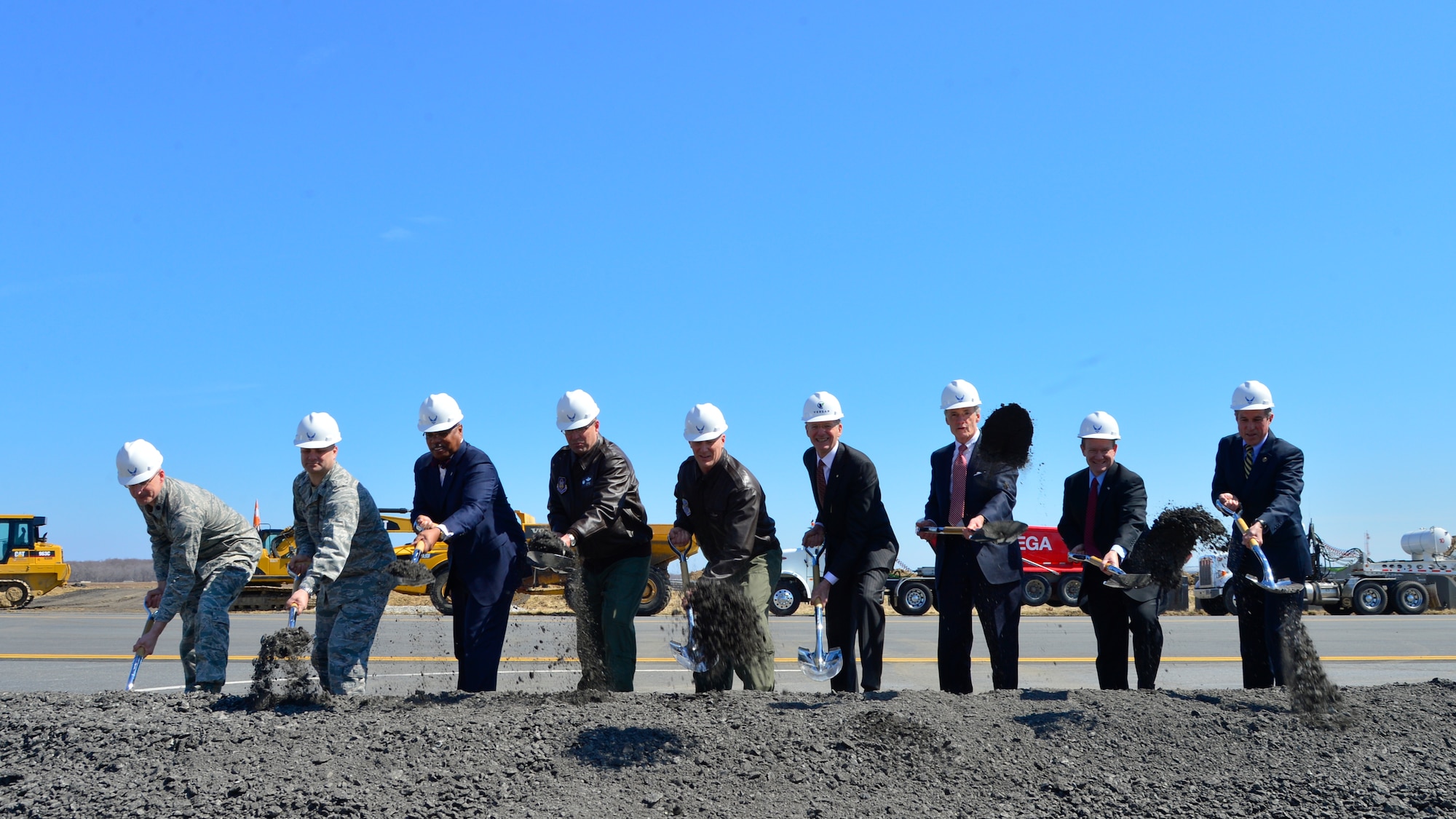 From left, Lt. Col. Scott Bryant, 436th Civil Engineer Squadron commander, Col. Brian May, Air Force Civil Engineer Center Facility Engineering director, John Bonapart, Air Mobility Command Installations and Mission Support director, Col. Raymond Kozak, 512th Airlift Wing commander, Col. Michael Grismer, 436th AW commander, Paul Hoeper, Versar Inc. Chairman of the Board, Sen. Tom Carper, D-Del., Sen. Chris Coons, D-Del., and Rep. John Carney D-Del., ceremonially shovel dirt at a Runway Repair Groundbreaking ceremony March 23, 2015, at Dover Air Force Base, Del. The $98.3 million project is projected to be complete in June 2016. (U.S. Air Force photo/Airman 1st Class William Johnson)