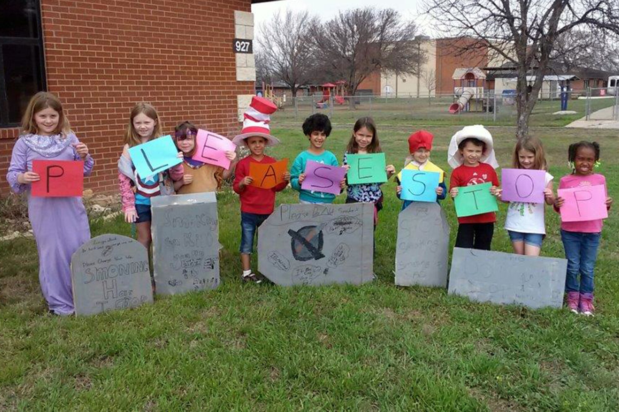 GOODFELLOW AIR FORCE BASE, Texas -- School Age Program students pose with personalized anti-tobacco messages by the school’s entrance March 18. The children made the messages for Kick Butts Day, a nationwide event encouraging kids to speak out against tobacco use. (Courtesy photo)