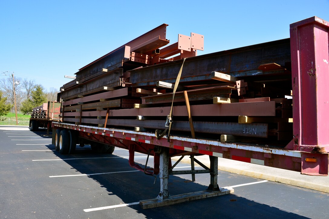 MCGHEE TYSON AIR NATIONAL GUARD BASE, Tenn. - Steel beams that help support the new classroom and dormitory facility at the I.G. Brown Training and Education Center rest prepositioned on trailers here March 23, 2015, in the student parking lot. Officials said they hope to erect initial steelwork in a few weeks. Construction began last August. (U.S. Air National Guard photo by Master Sgt. Jerry D. Harlan/Released) 