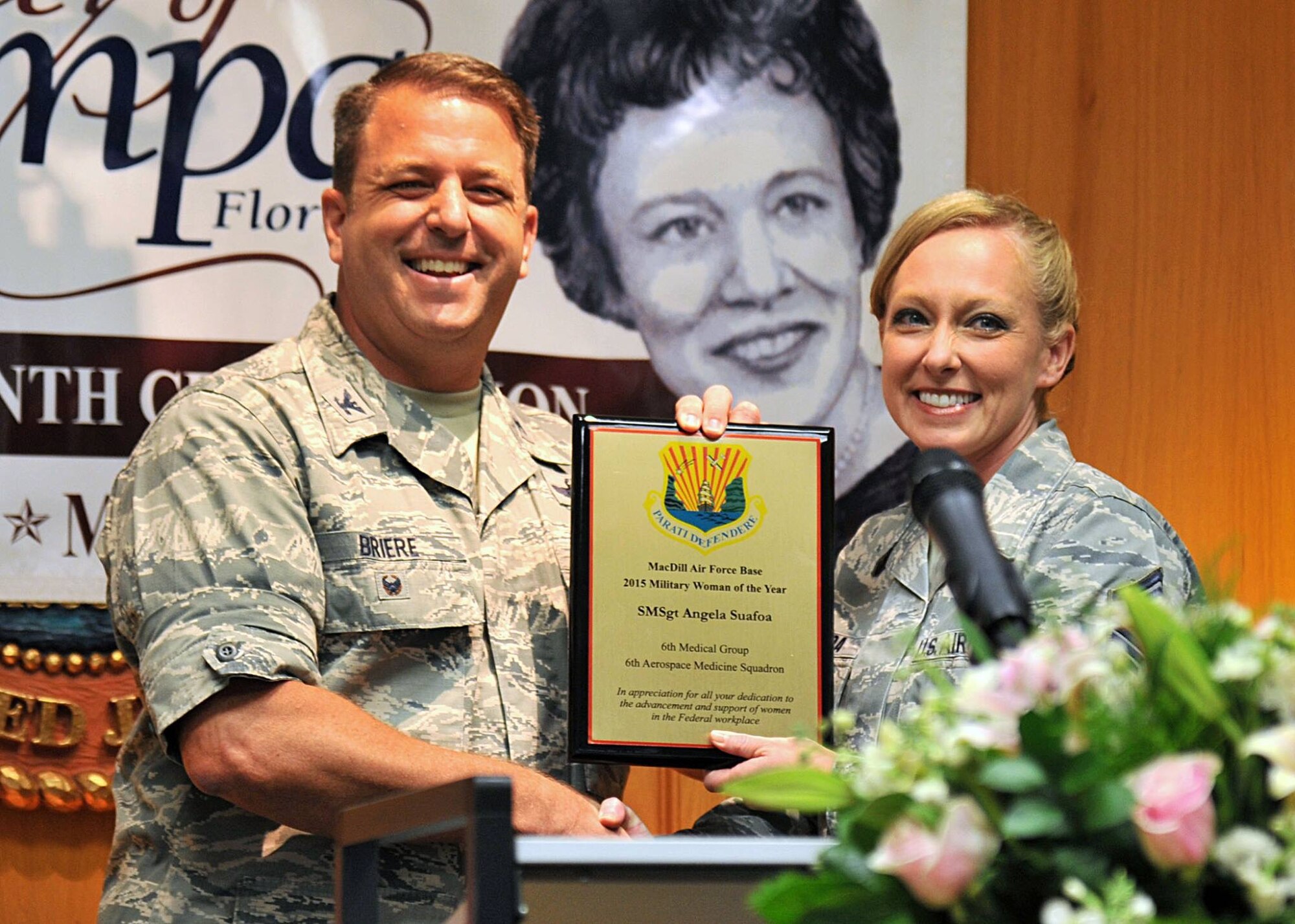 Col. Andre Briere 6th Air Mobility Wing vice commander present Senior master Sgt. Angela Suafoa, 6th Aerospace Medicine Squadron superintendent, with the City of Tampa 2015 Military Woman of the Year award, March 18, 2015, Tampa, Fla. Suafoa’s dedication to the men and women of the 6th Air Mobility Wing were continuously displayed as she counseled and guided Airmen and their families, all while epitomizing the Air Force’s definition of a senior noncommissioned officer. (U.S. Air Force photo by Staff Sgt. Brittany Liddon/Released)