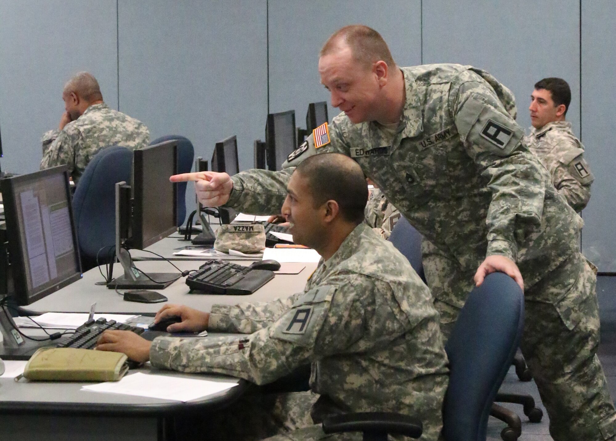 Army Sgts. 1st Class Panki Miah and Paul Edwards discuss a a practical exercise during this month's Battle Staff Noncommissioned Officers Course held at Army Support Activity Fort Dix Distance Learning Center on Joint Base McGuire-Dix-Lakehurst, N.J., March 1-31, 2015. (U.S. Army photo by Maj. Antonia Greene-Edwards/Released)