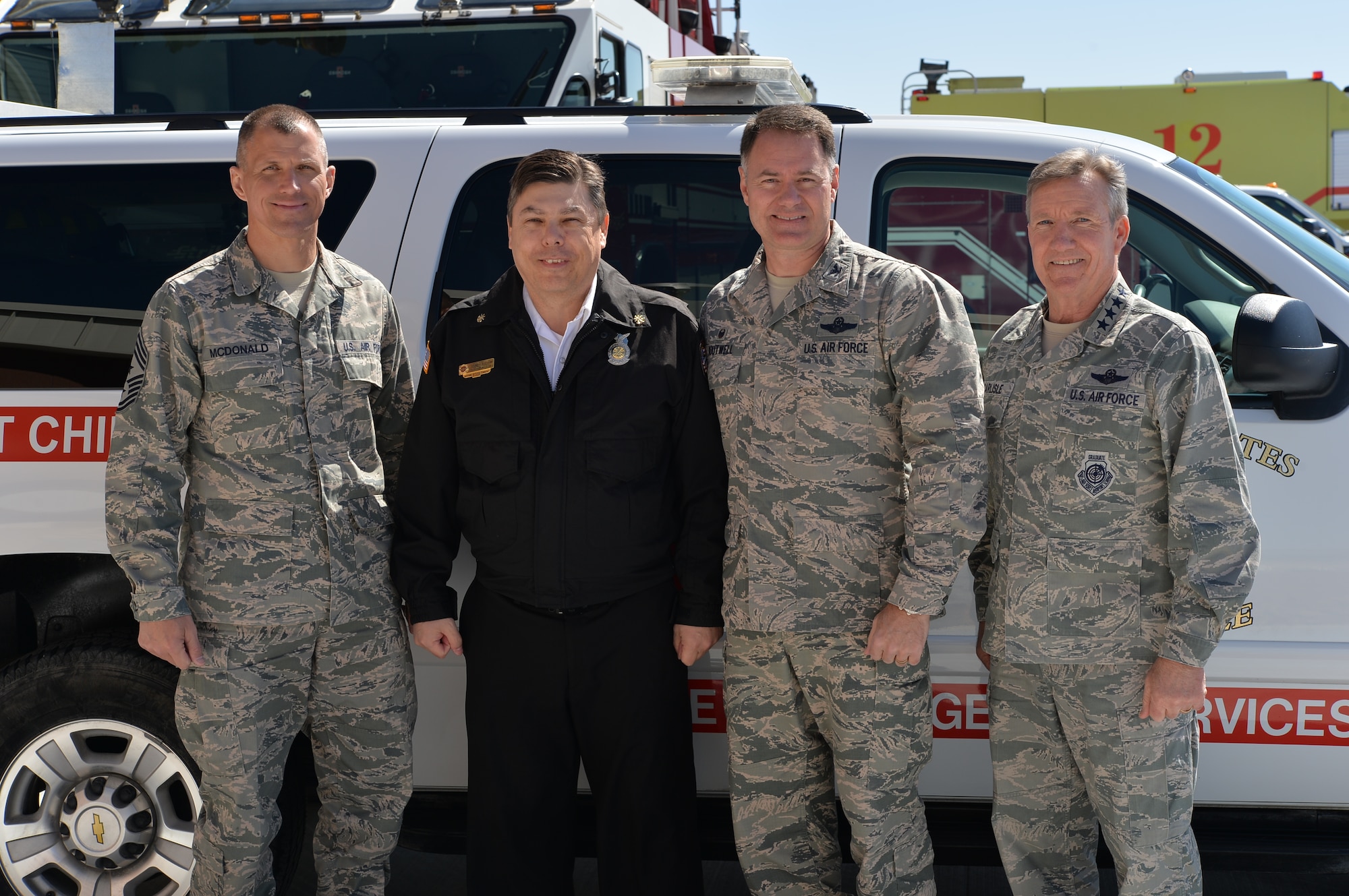 Right to left, U.S. Air Force Gen. Hawk Carlisle, commander of Air Combat Command, Col. Richard Boutwell, 99th Air Base Wing commander, John Beauchamp, Nellis-Creech Fire Emergency Services fire chief, and Chief Master Sgt. Steve McDonald, ACC command chief, pose for a photo following the ribbon cutting ceremony for Fire Station 6 on March 4, 2015, at Creech Air Force Base, Nevada. The new fire house provides a location for fire trucks and firefighters to quickly respond to the growing northern portion of the base. (U.S. Air Force photo by Senior Airman Adarius Petty/Released)