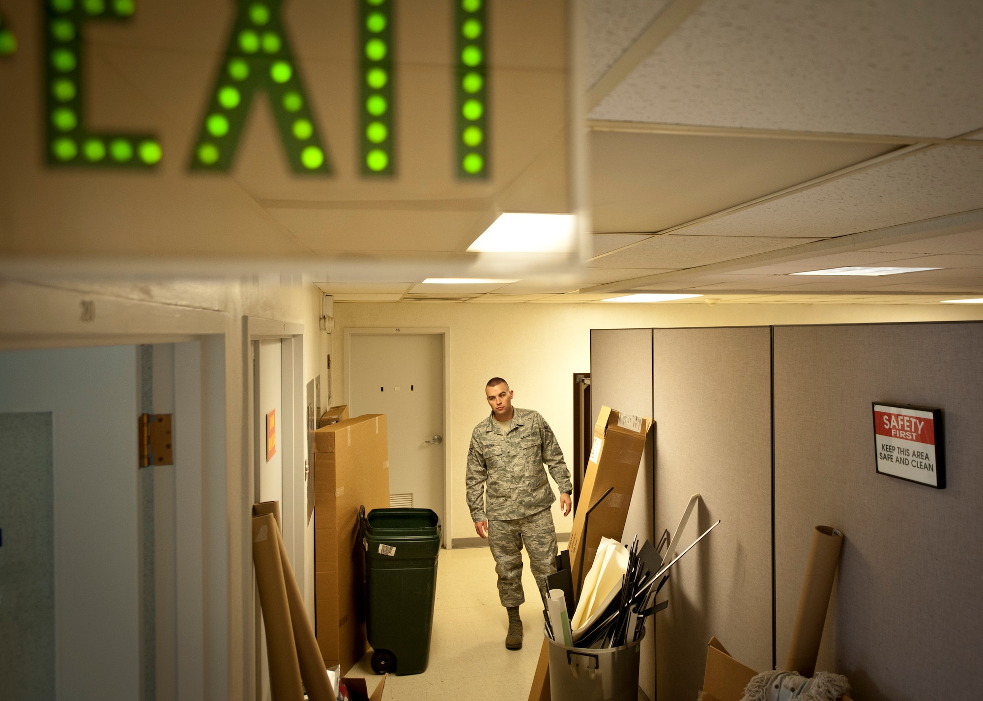PETERSON AIR FORCE BASE, Colo. -- Staff Sgt. Aaron Breeden, 21st Space Wing photojournalist, shows an example of how a hallway filled with trash and debris can pose an egress hazard in the event of an emergency. As spring cleaning season nears, clearing hazards such as these from your home and workplace will help ensure other's safety should the unthinkable occur. (U.S. Air Force photo by Staff Sgt. J. Aaron Breeden)