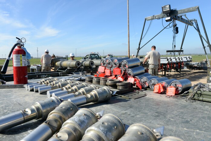 Airmen inspect munitions equipment at a munition pad on Beale Air Force Base, Calif., March 17, 2015. The Airmen were attending the Combat Ammunition Planning and Production course, which is an upgrade requirement for all 2W0 munitions system personnel. (U.S. Air Force photo by Senior Airman Bobby Cummings/Released)