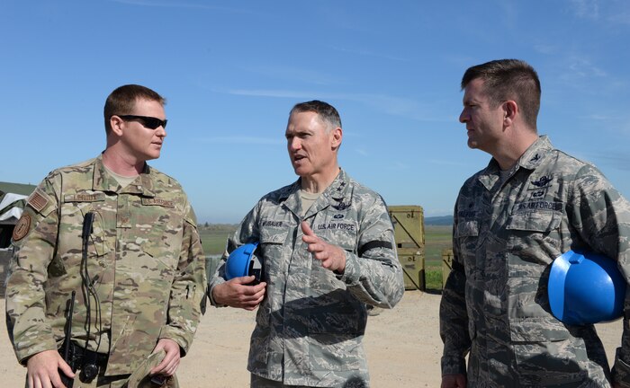 Maj. Gen. Kurt Neubauer (center), the Air Force Chief of Safety, discusses safety procedures with Staff Sgt. Christopher Leroux (left), 9th Munitions Squadron combat munitions advisor, and Col. Darren Halford, 9th Operations Group commander, on a munitions pad at Beale Air Force Base, Calif., March 17, 2015. Neubauer was attending a Senior Officer Orientation course at the Air Force Combat Ammunition Center located on Beale Air Force Base. (U.S. Air Force photo by Senior Airman Bobby Cummings/Released)