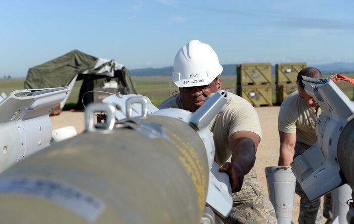 Tech Sgt. Edwin Evans Jr., 2nd Munitions Squadron munitions inspector, Barksdale Air Force Base, La., inspects ammunition at a munitions pad on Beale Air Force Base, Calif., March 17, 2015. Evans Jr. was attending the Combat Ammunition Planning and Production course at the Air Force Combat Ammunition Center located on Beale Air Force Base. (U.S. Air Force photo by Senior Airman Bobby Cummings/Released)